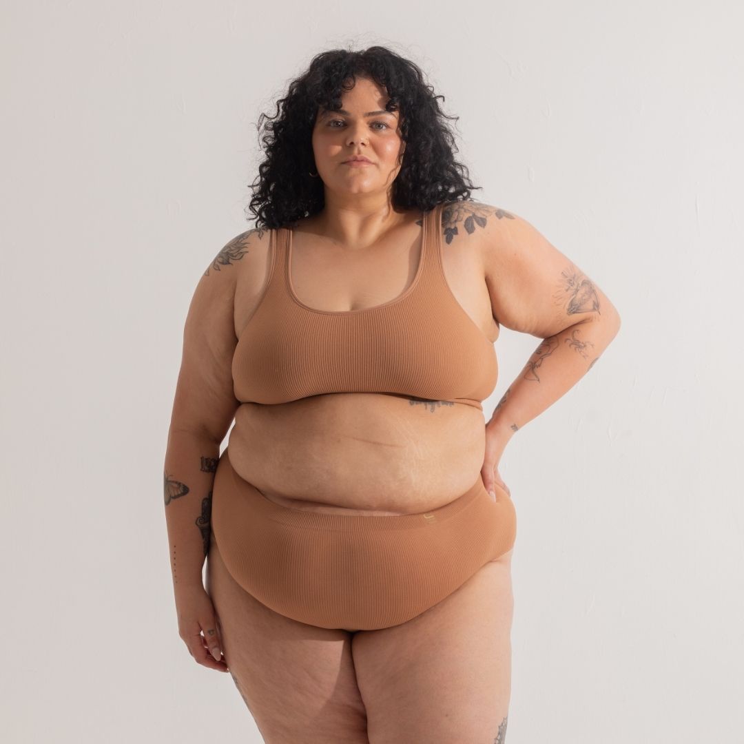 Sustainable, ethically produced Nude 4- tan olive skin tone bra crop by Underwear for Humanity: stronger support for larger bust, D - GG cup sizes. Recycled materials, knitted bra and band, seamfree, made from recycled nylon. Models wear the D+ Crop