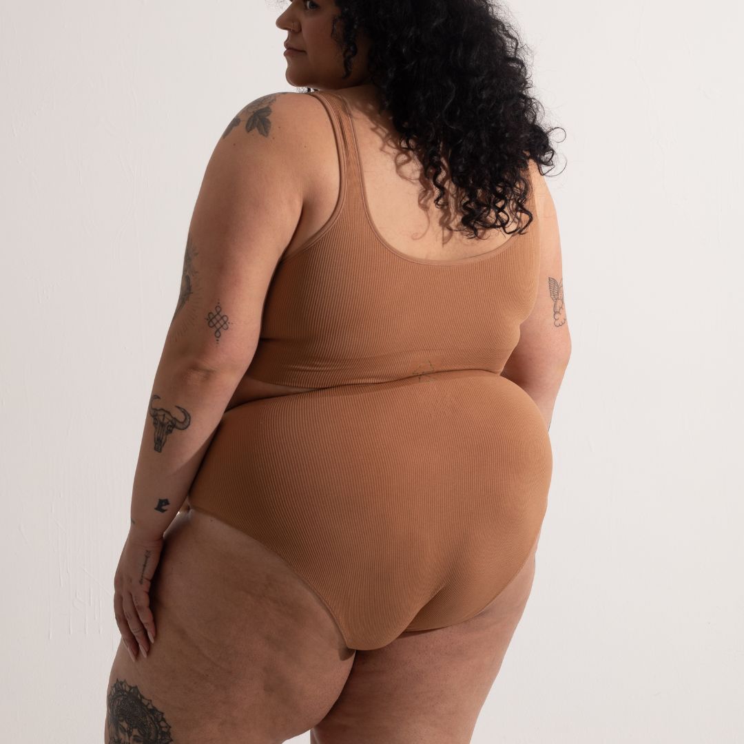 Sustainable nude 4 tan olive skin tone seam free high waist brief by Underwear for Humanity: ethical, sustainable. sizes 6-26. light, breathable, stretches across sizes. Models wear high-waisted underwear. underwear sits high on the waist, full seat coverage, Seam free underwear. made from recycled nylon