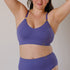 Sustainable, ethically produced light purple wireless bra by Underwear for Humanity. For DD-GG cup sizes. Recycled materials, flexible, supportive. Knitted bra and band, adjustable straps. Model wears the DD+ bra.