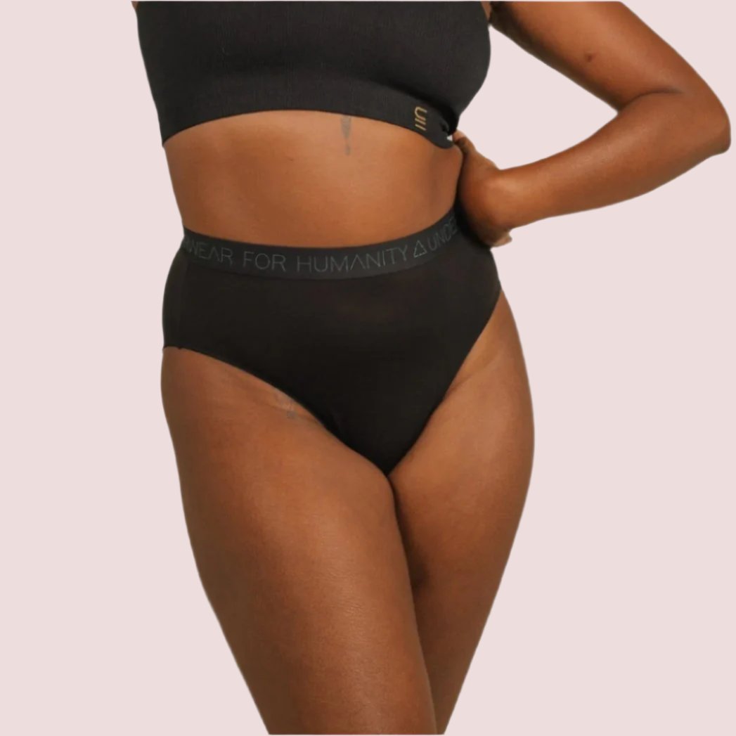Sustainable black high waist brief by Underwear for Humanity: ethical, sustainable. sizes 6-30 light, breathable. Models wear high-waisted underwear. underwear sits high on the waist, full seat coverage. smooth under clothing. made from Tencel and recycled materials, attached no-dig recycled elastic waist band.