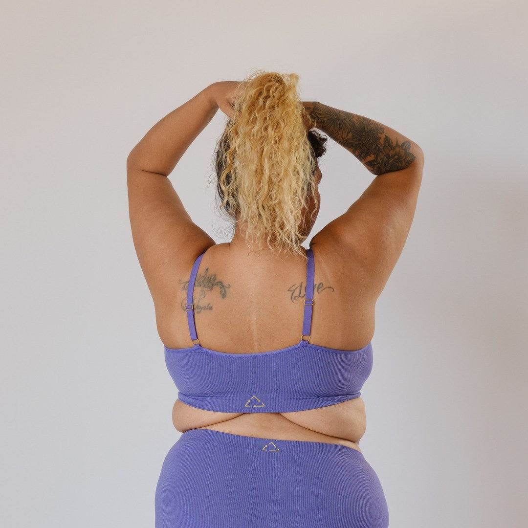 Sustainable, ethically produced light purple wireless bra by Underwear for Humanity. For DD-GG cup sizes. Recycled materials, flexible, supportive. Knitted bra and band, adjustable straps. Model wears the DD+ bra.