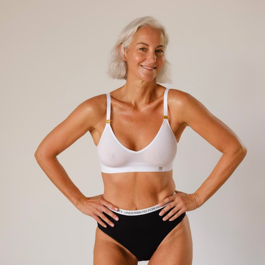 Sustainable, ethically produced White wireless bra by Underwear for Humanity. A -D cup sizes. Recycled materials, flexible, supportive. Knitted bra and band, adjustable straps. Models wear the A-D bra.