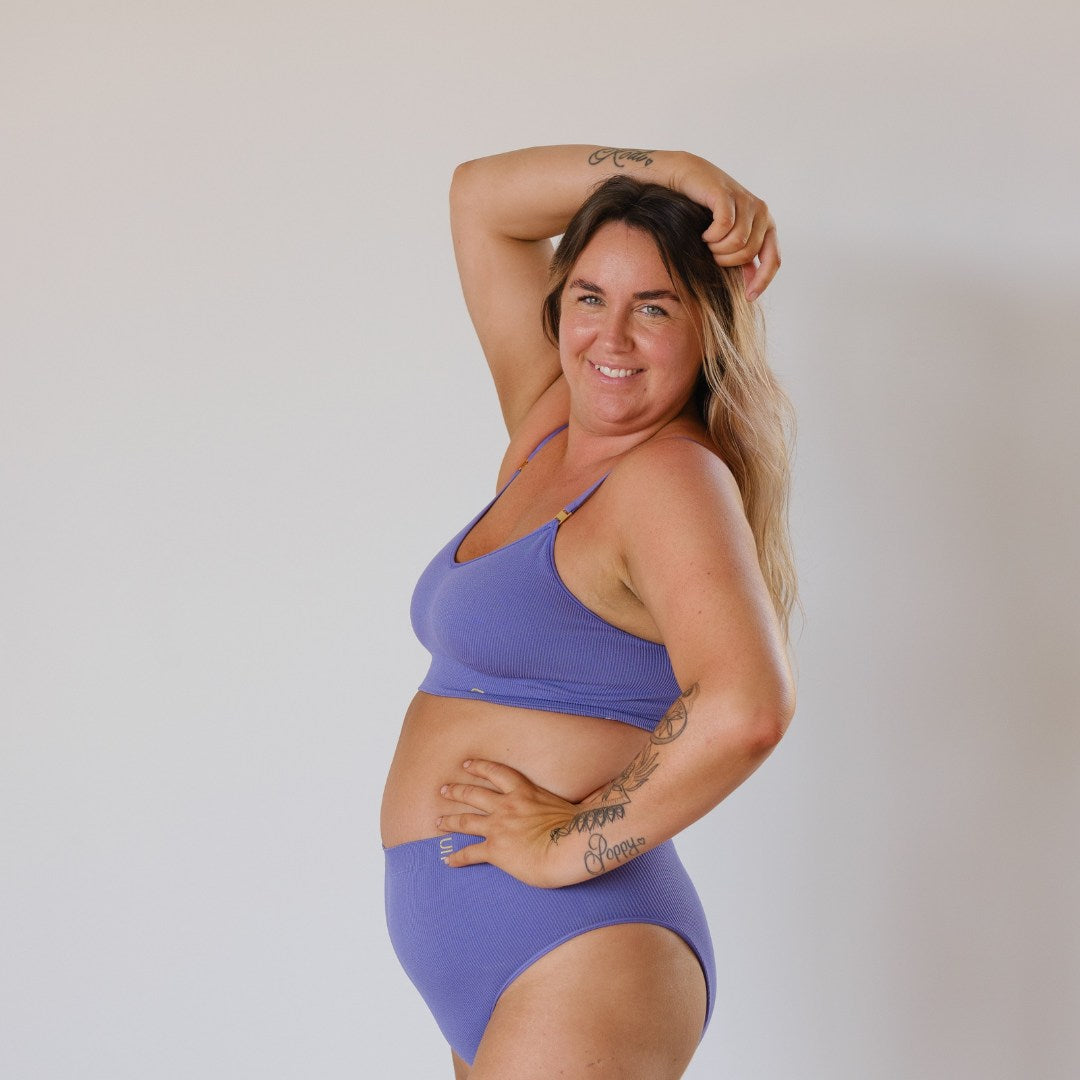 Sustainable, ethically produced light purple wireless bra by Underwear for Humanity. For DD-GG cup sizes. Recycled materials, flexible, supportive. Knitted bra and band, adjustable straps. Model wears the DD+ bra.