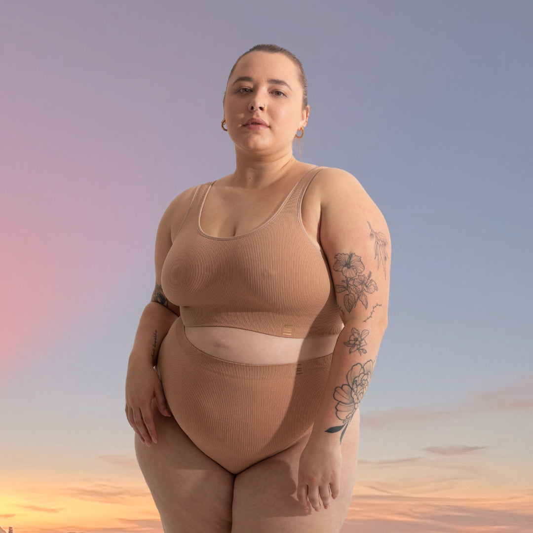 Sommai wears our recycled nylon high waist brief in nude 4. light beige tone, seamfree, sustainable and ethically made