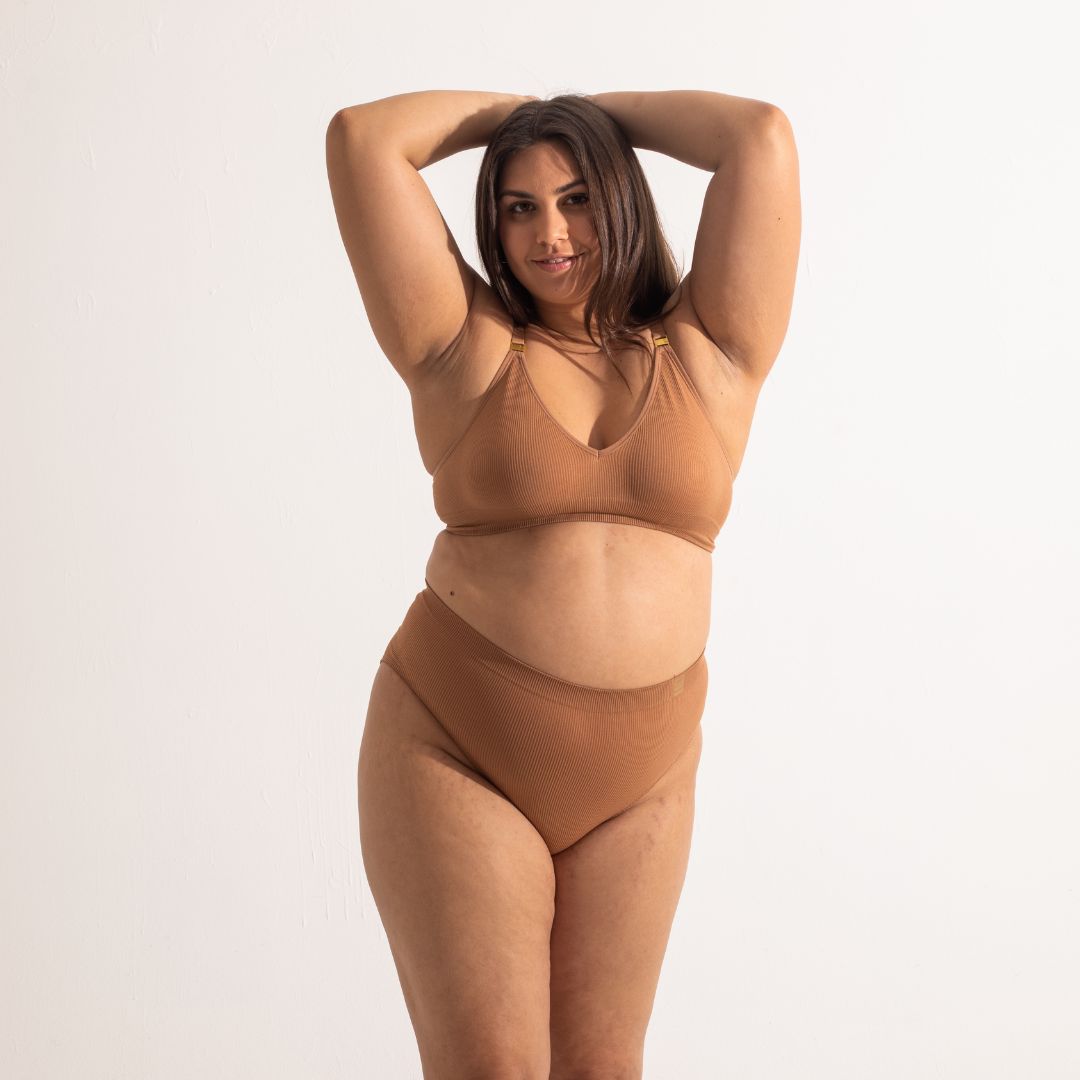 Sustainable nude 4 tan olive skin tone seam free high waist brief by Underwear for Humanity: ethical, sustainable. sizes 6-26. light, breathable, stretches across sizes. Models wear high-waisted underwear. underwear sits high on the waist, full seat coverage, Seam free underwear. made from recycled nylon