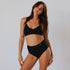 Sustainable, ethically made Black high waist seam free brief by Underwear for Humanity: Flexible and comfortable, stretches across sizes. Models wear high waisted ethical underwear. Underwear is made from recycled nylon and sits high on the waist, full seat coverage and smooth on the body.