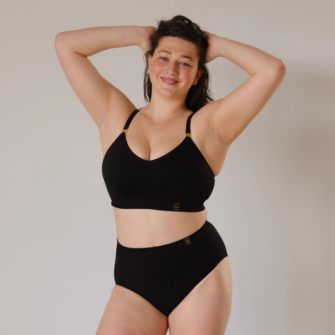 Sustainable, ethically made Black high waist seam free brief by Underwear for Humanity: Flexible and comfortable, stretches across sizes. Models wear high waisted ethical underwear. Underwear is made from recycled nylon and sits high on the waist, full seat coverage and smooth on the body.
