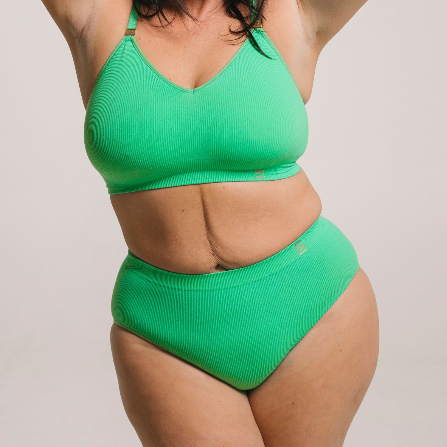 Sustainable, ethically made apple high waist seam free brief by Underwear for Humanity: Flexible and comfortable, stretches across sizes. Models wear high waisted ethical underwear. Underwear is made from recycled nylon and sits high on the waist, full seat coverage and smooth on the body.