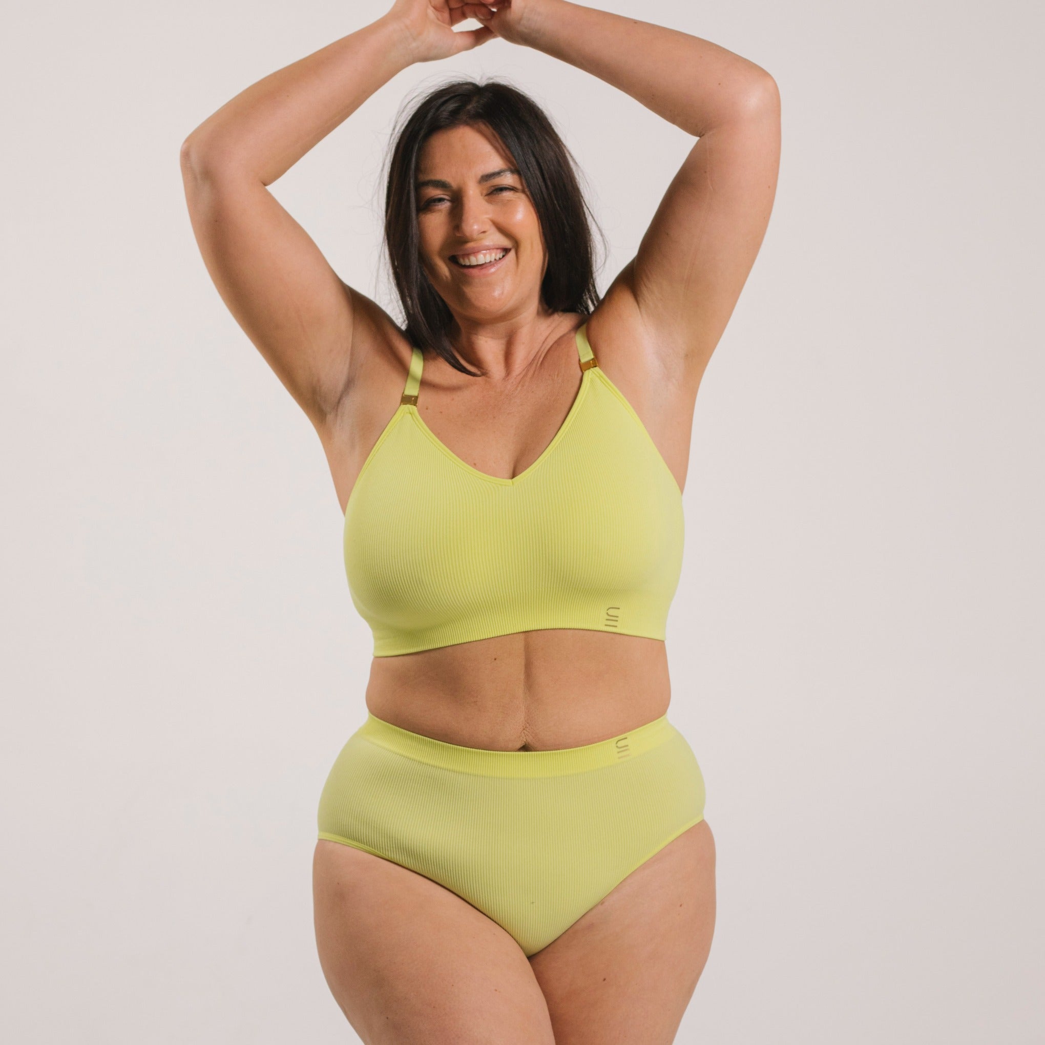Sustainable, ethically made Lime high waist seam free brief by Underwear for Humanity: Flexible and comfortable, stretches across sizes. Models wear high waisted ethical underwear. Underwear is made from recycled nylon and sits high on the waist, full seat coverage and smooth on the body.