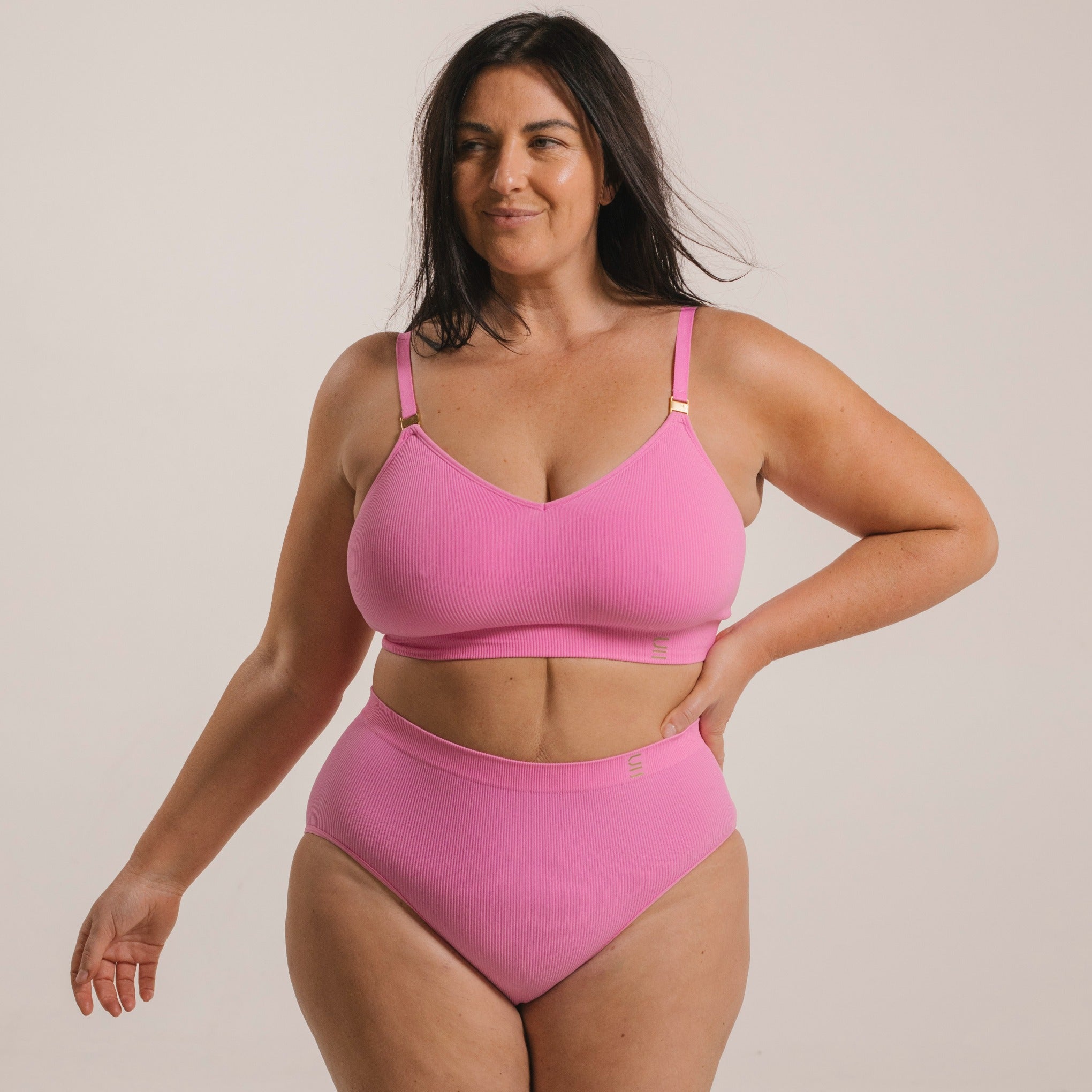 Sustainable pink high waist brief by Underwear for Humanity: ethical, sustainable. sizes 6-30 light, breathable. Models wear high-waisted underwear. underwear sits high on the waist, full seat coverage. smooth under clothing. made from Tencel and recycled materials, attached no-dig recycled elastic waist band.