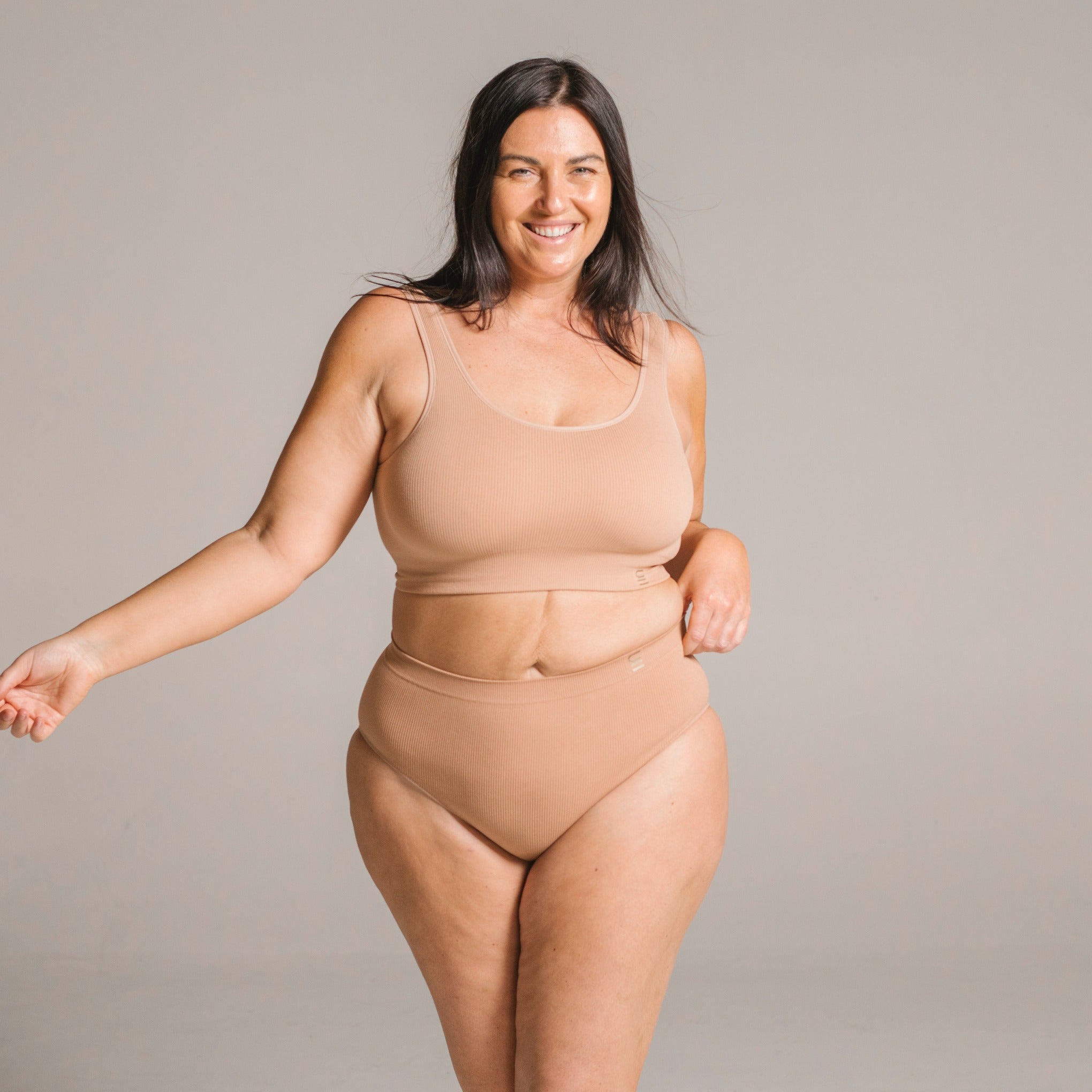 Sustainable, ethically produced nude 3- light beige skin tone bra crop by Underwear for Humanity: stronger support for larger bust, D - GG cup sizes. Recycled materials, knitted bra and band, seamfree, made from recycled nylon. Models wear the D+ Crop