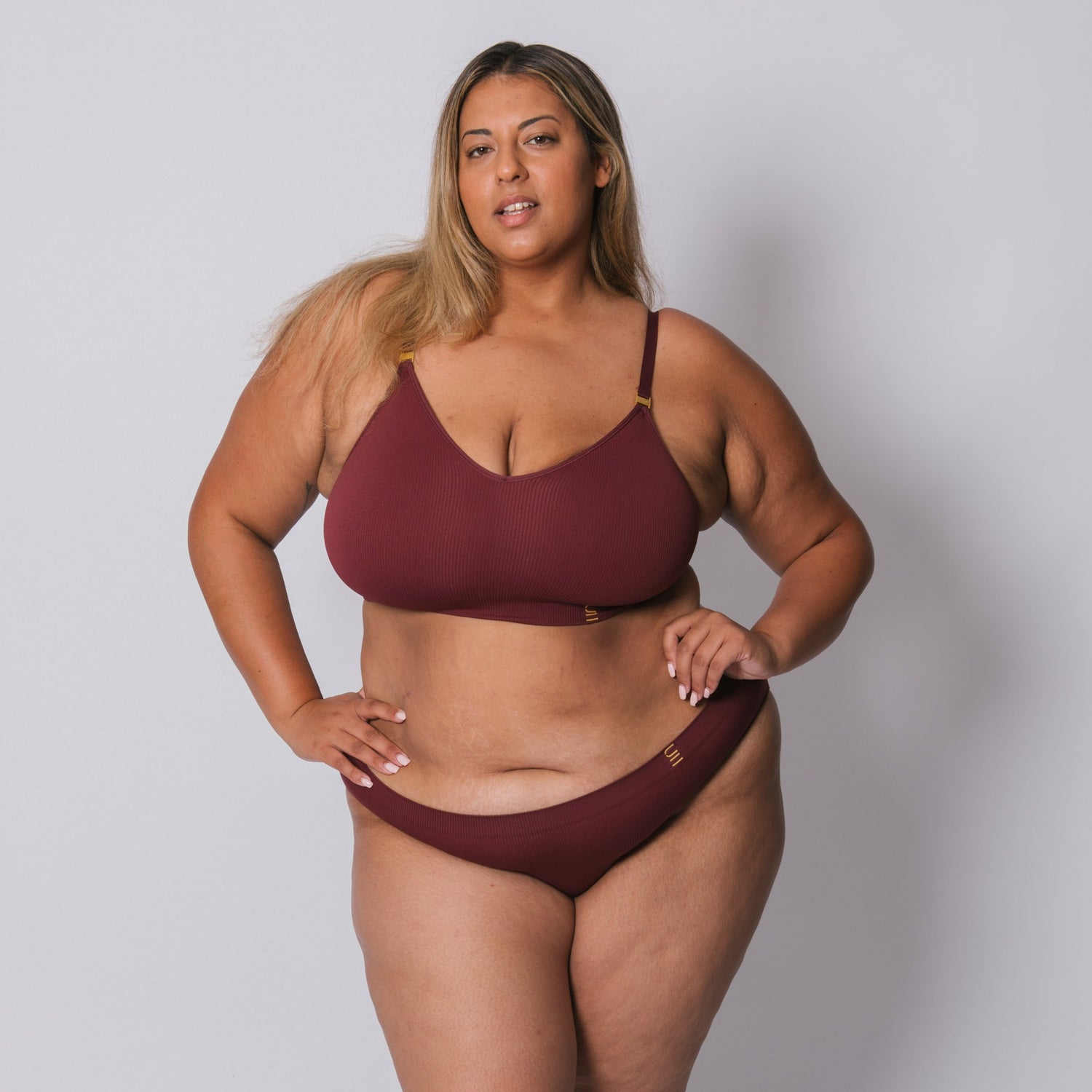 Sustainable, ethically made Cranberry high waist seam free brief by Underwear for Humanity: Flexible and comfortable, stretches across sizes. Models wear high waisted ethical underwear. Underwear is made from recycled nylon and sits high on the waist, full seat coverage and smooth on the body.
