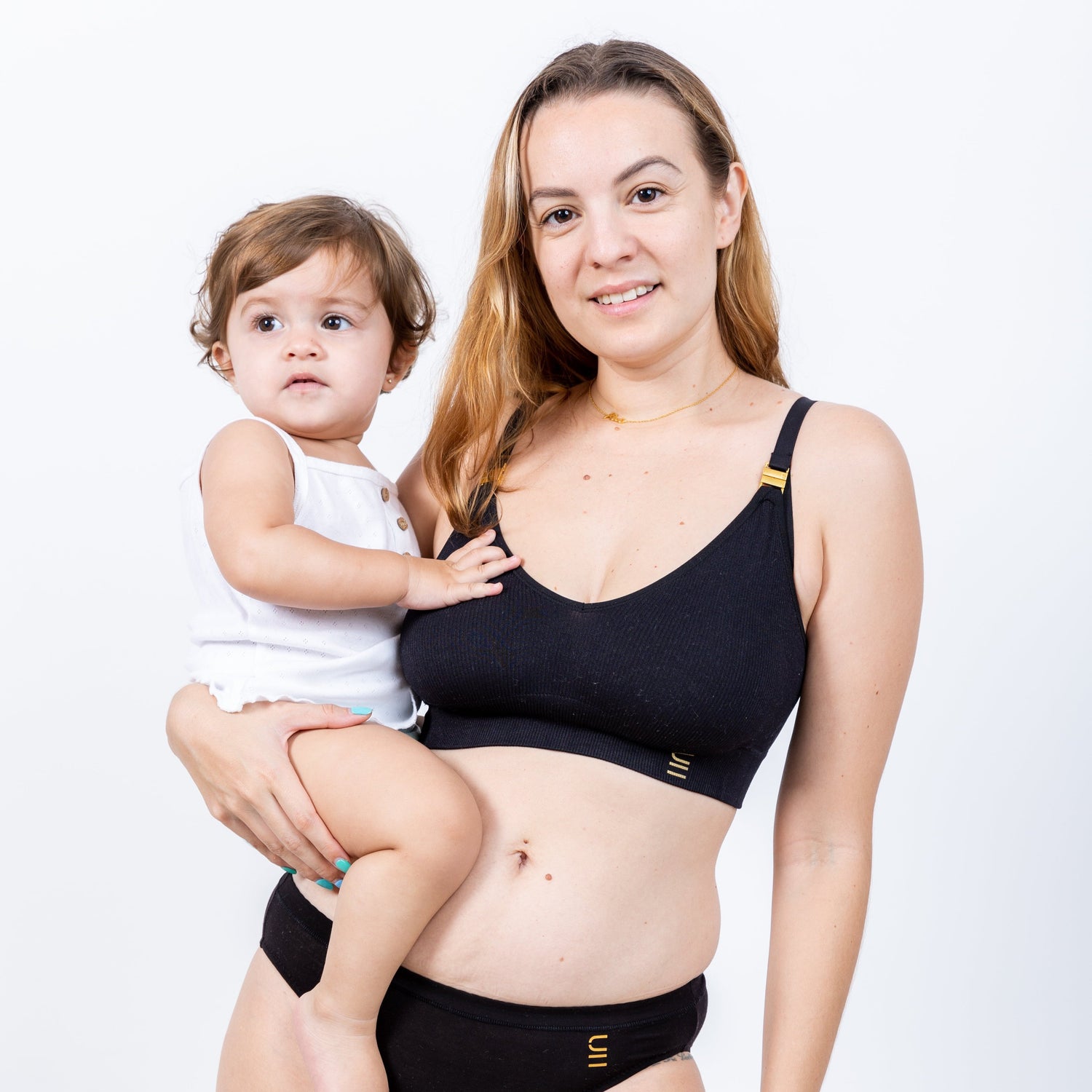 Sustainable black wireless maternity bra by Underwear for Humanity: ethical, sustainable. A -D and DD-GG cup sizes. Recycled materials, flexible, supportive, pregnancy, feeding, convertible. Knitted bra and band, adjustable straps. Models showcases maternity bra