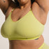 Sustainable, ethically produced lime wireless bra by Underwear for Humanity. For DD-GG cup sizes. Recycled materials, flexible, supportive. Knitted bra and band, adjustable straps. Model wears the DD+ bra.