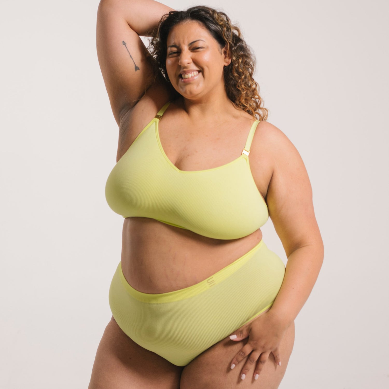 Sustainable, ethically made Lime high waist seam free brief by Underwear for Humanity: Flexible and comfortable, stretches across sizes. Models wear high waisted ethical underwear. Underwear is made from recycled nylon and sits high on the waist, full seat coverage and smooth on the body.