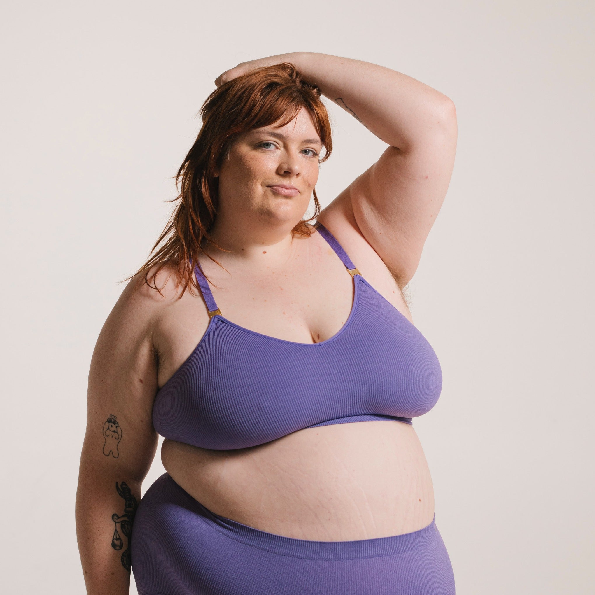 Sustainable, ethically produced light purple wireless bra by Underwear for Humanity. For DD-GG cup sizes. Recycled materials, flexible, supportive. Knitted bra and band, adjustable straps. Model wears the DD+ bra.