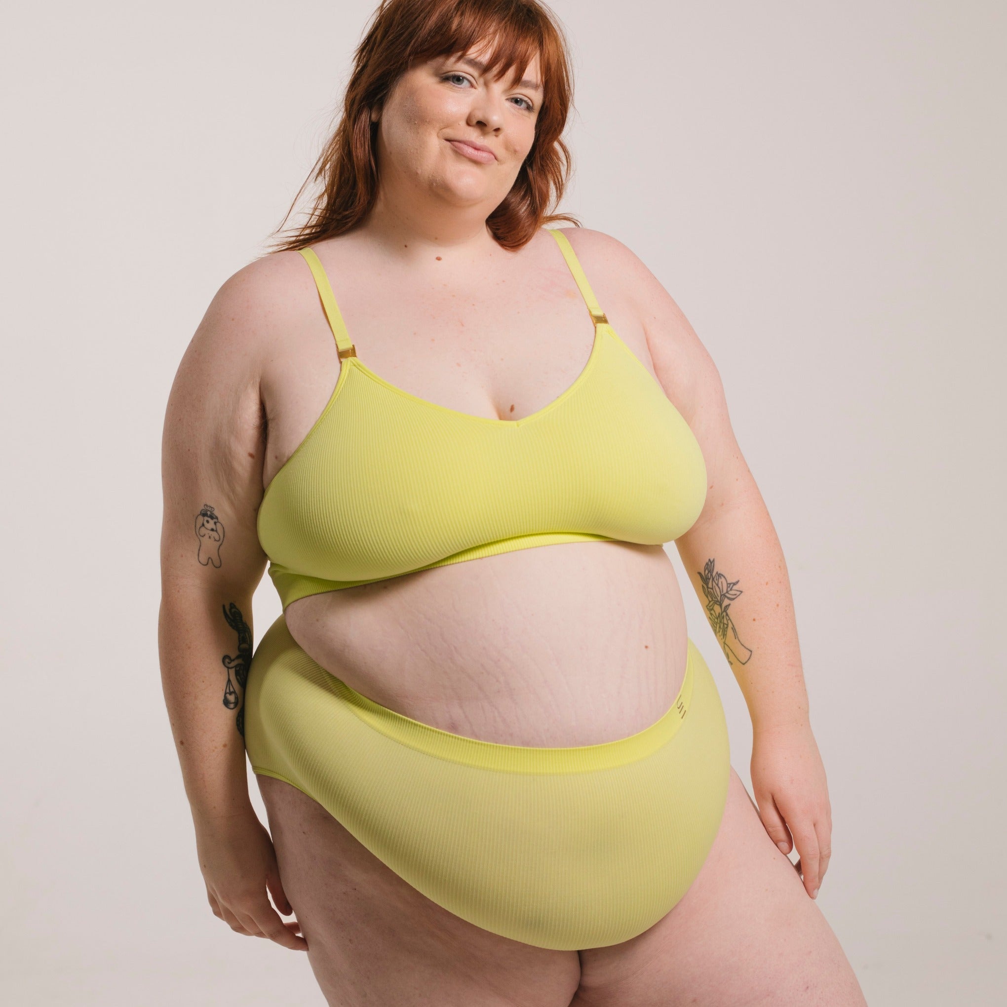Sustainable, ethically made Lime high waist seam free brief by Underwear for Humanity: Flexible and comfortable, stretches across sizes. Models wear high waisted ethical underwear. Underwear is made from recycled nylon and sits high on the waist, full seat coverage and smooth on the body.