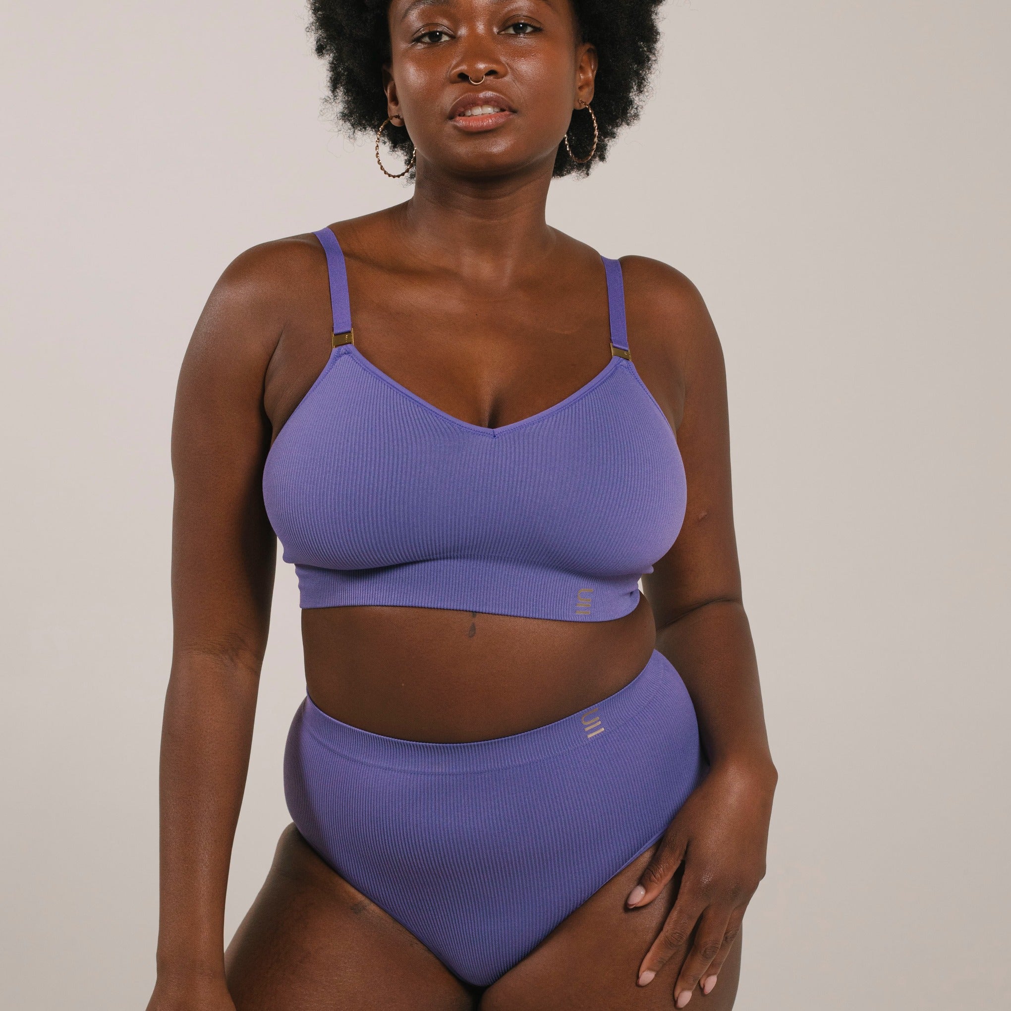 Sustainable, ethically produced light purple wireless bra by Underwear for Humanity. For DD-GG cup sizes. Recycled materials, flexible, supportive. Knitted bra and band, adjustable straps. Model wears the DD+ bra.
