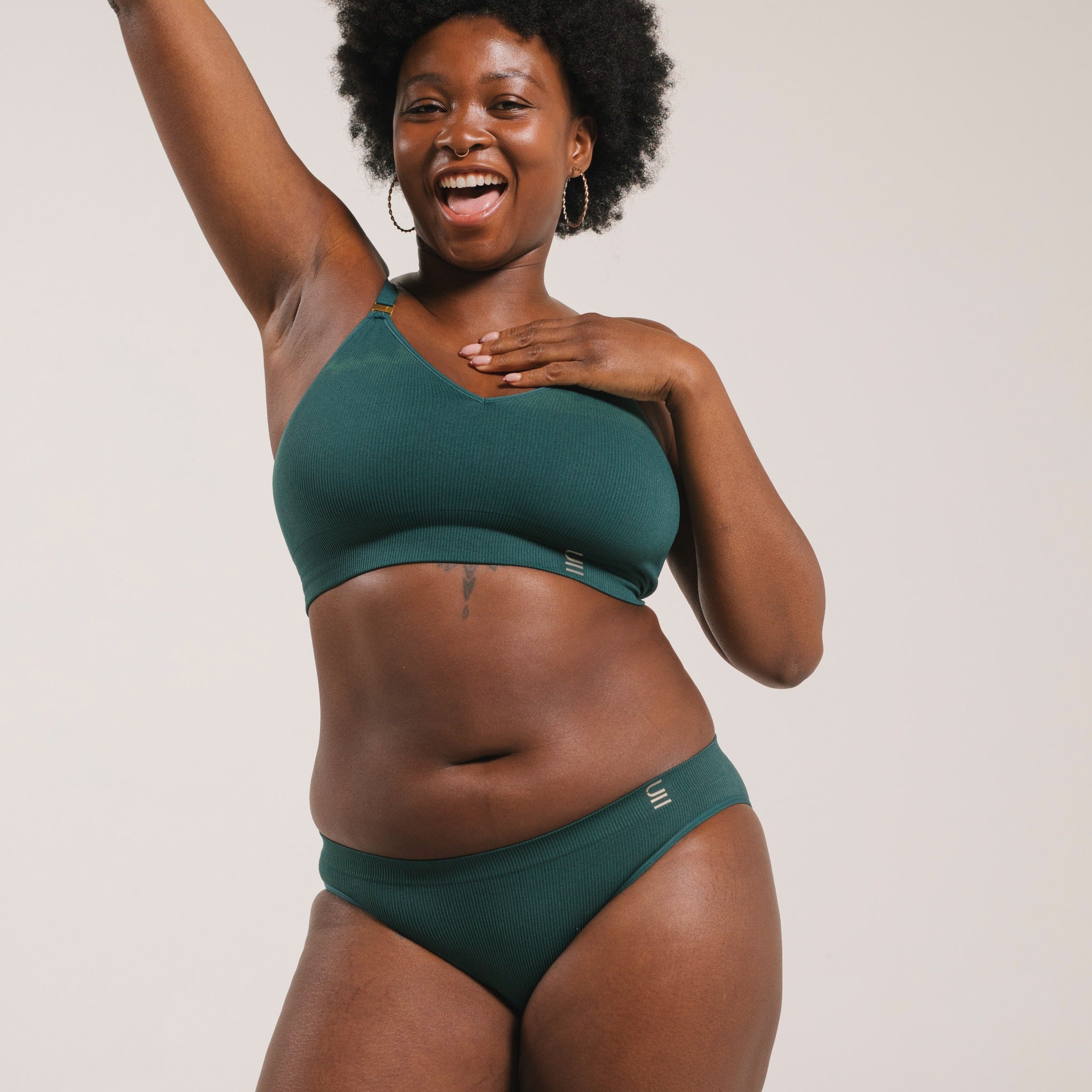 Ethically made recycled seam free atlantis bikini brief by Underwear for Humanity: Flexible and comfortable, stretches across sizes. Models wear bikini brief underwear. Underwear is made from recycled nylon and sits low on the waist, full seat coverage and smooth on the body.