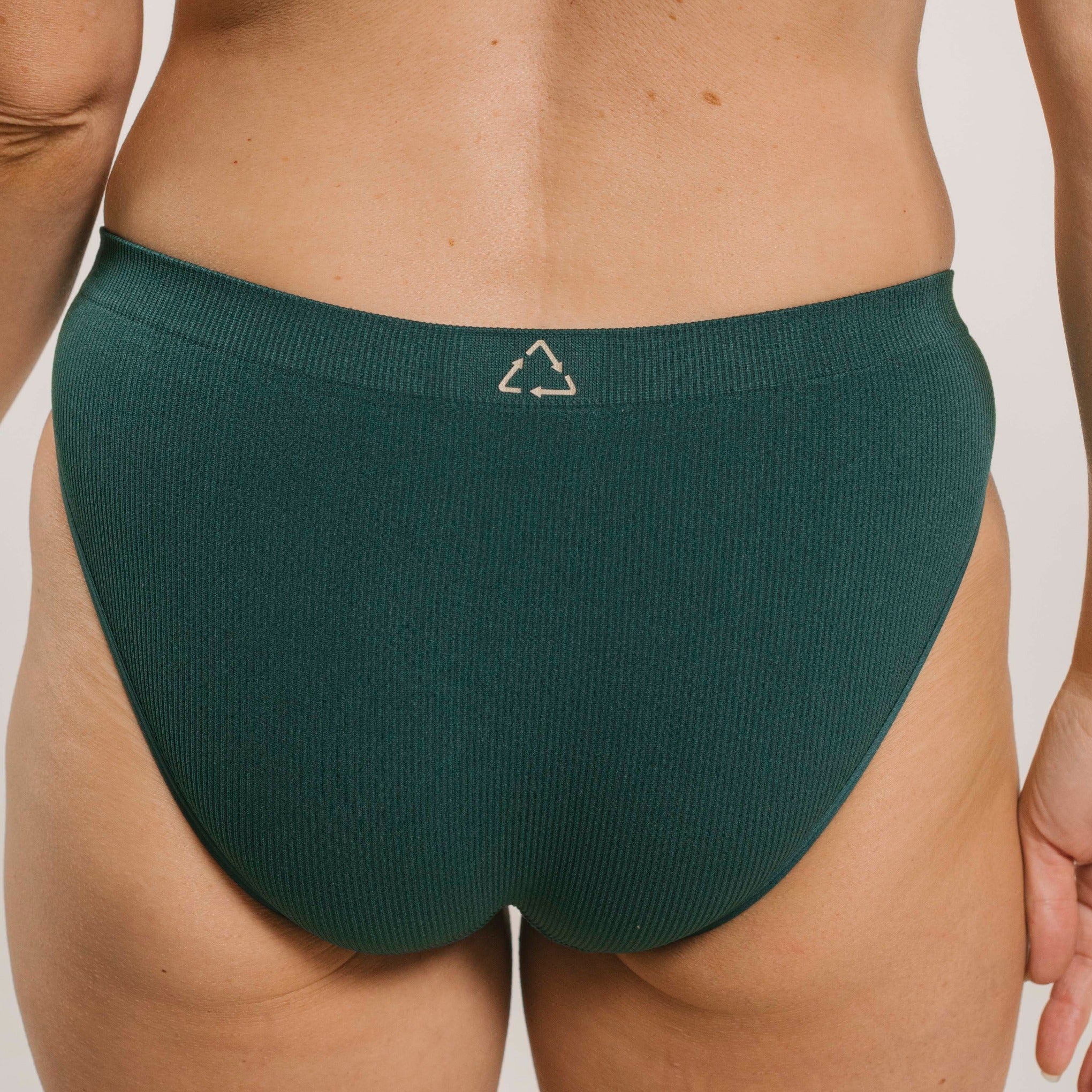 Ethically made recycled seam free atlantis bikini brief by Underwear for Humanity: Flexible and comfortable, stretches across sizes. Models wear bikini brief underwear. Underwear is made from recycled nylon and sits low on the waist, full seat coverage and smooth on the body.