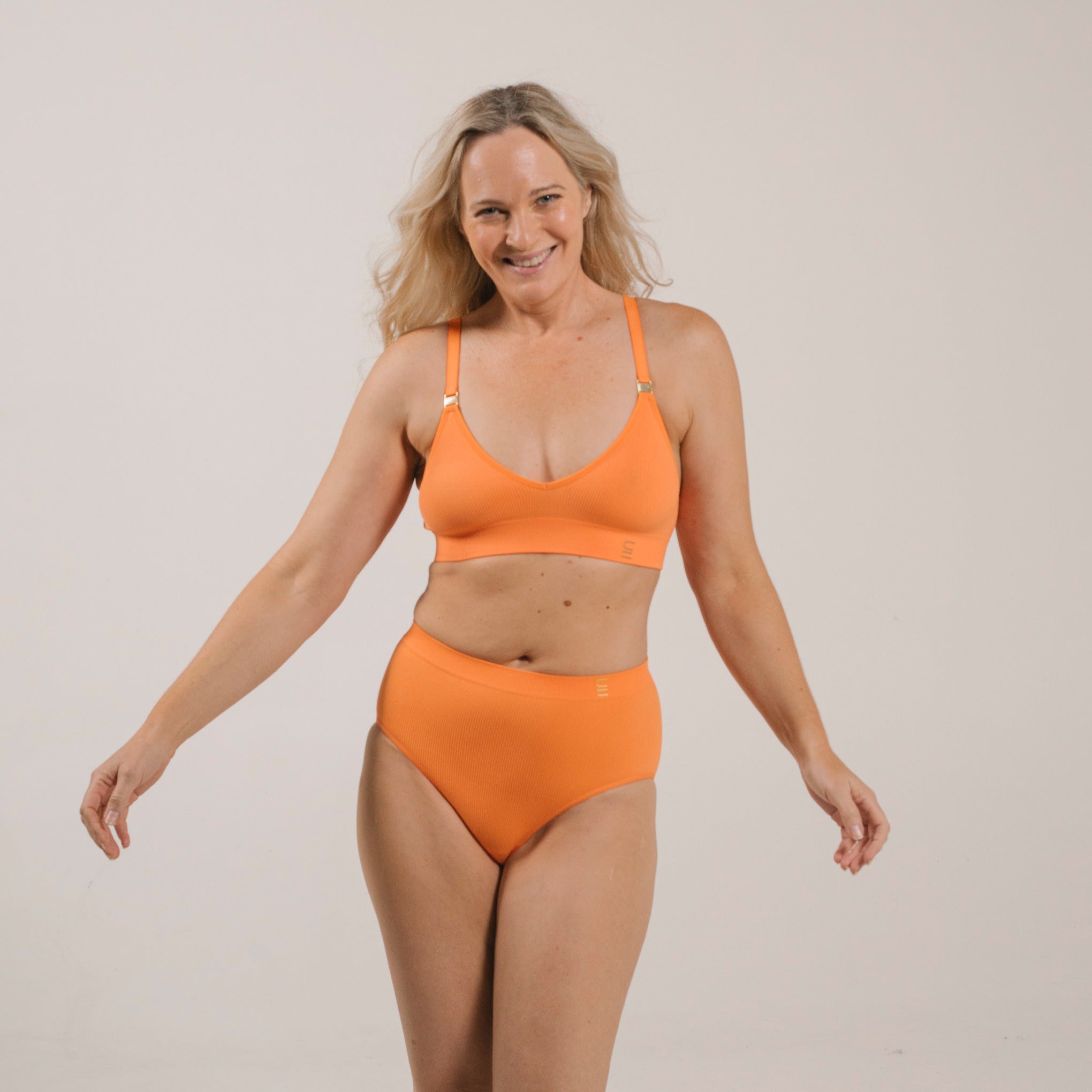 Sustainable, ethically produced mandarin wireless bra by Underwear for Humanity. A -D cup sizes. Recycled materials, flexible, supportive. Knitted bra and band, adjustable straps. Models wear the A-D bra.