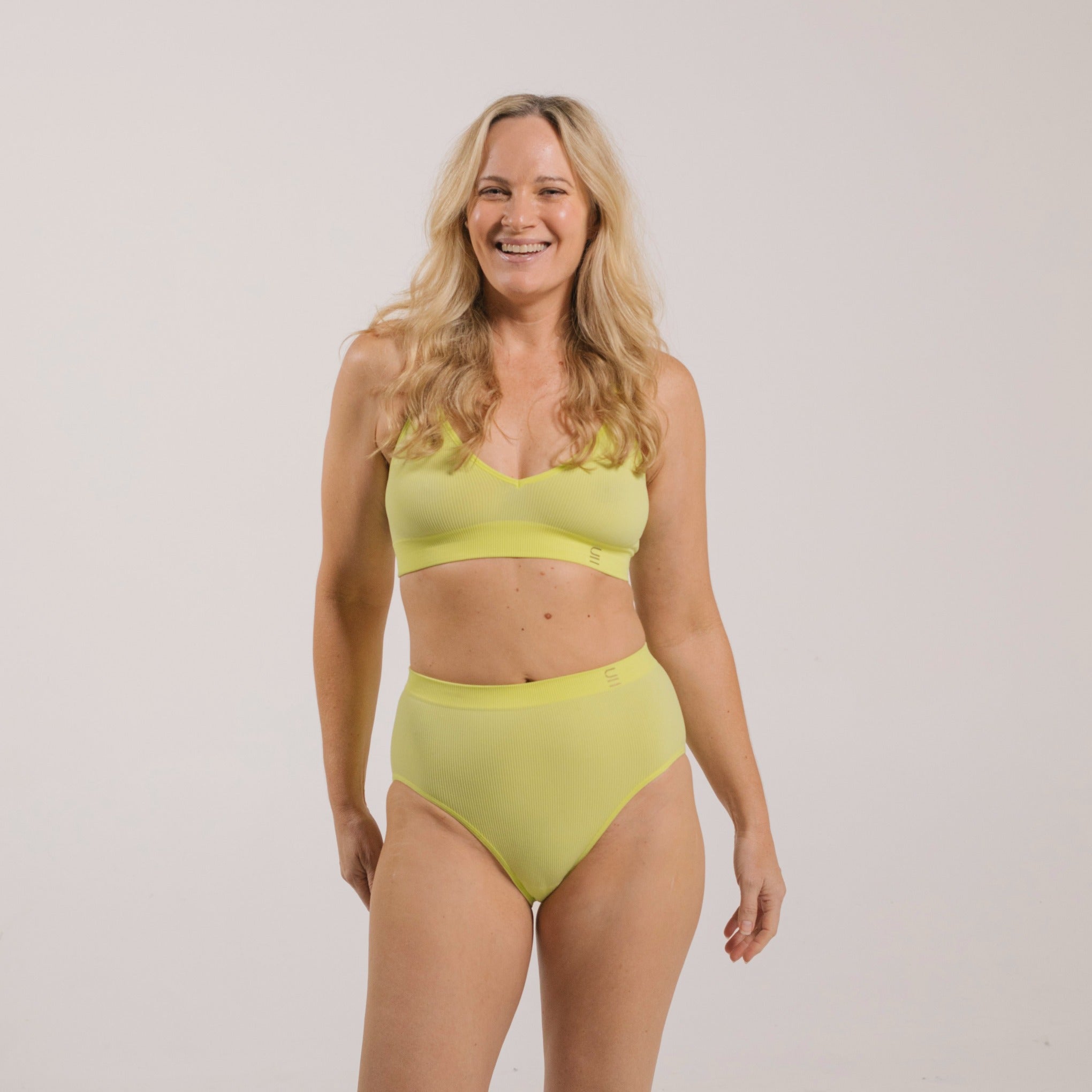 Sustainable, ethically produced lime wireless bra by Underwear for Humanity. A -D cup sizes. Recycled materials, flexible, supportive. Knitted bra and band, adjustable straps. Models wear the A-D bra.