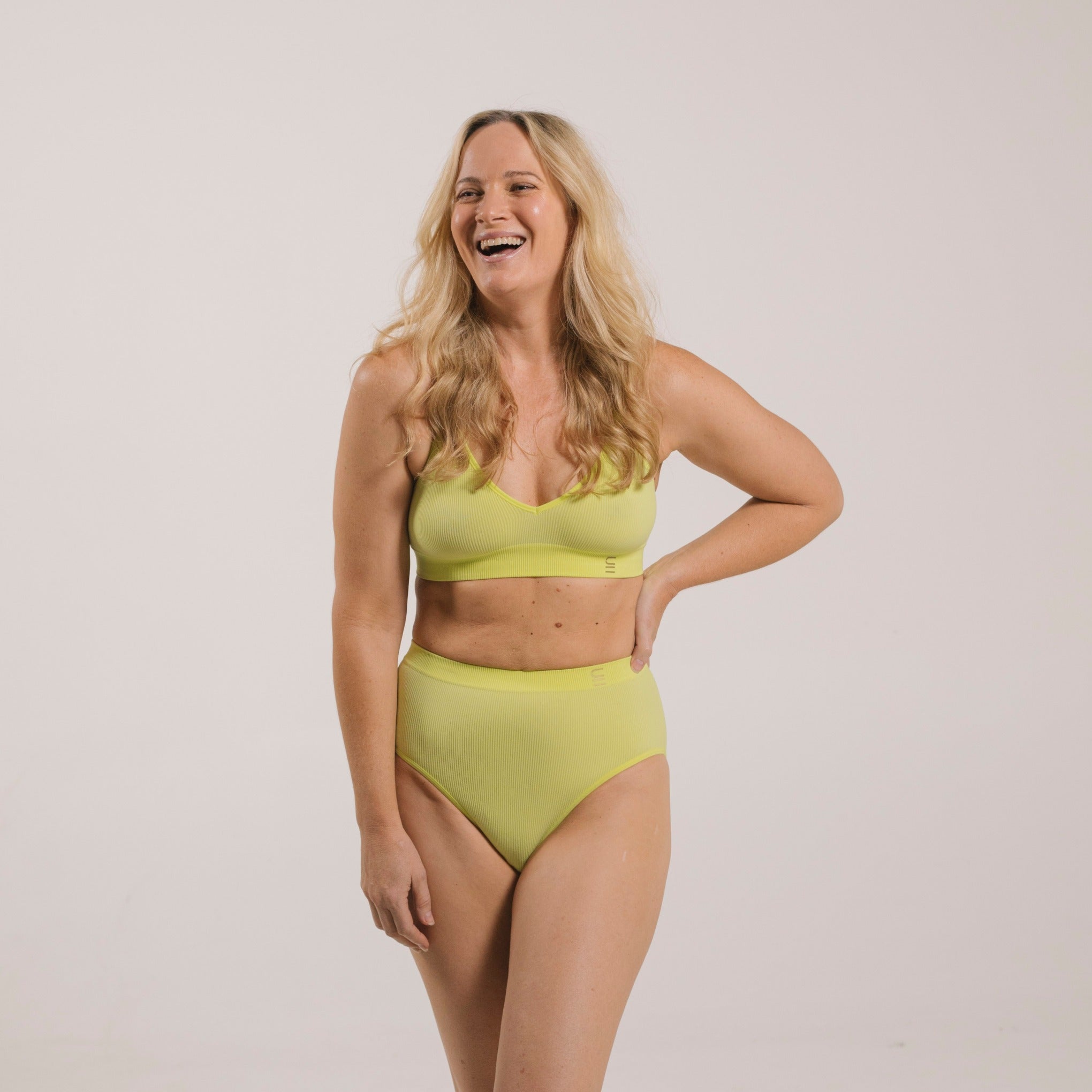 Sustainable, ethically produced lime wireless bra by Underwear for Humanity. A -D cup sizes. Recycled materials, flexible, supportive. Knitted bra and band, adjustable straps. Models wear the A-D bra.