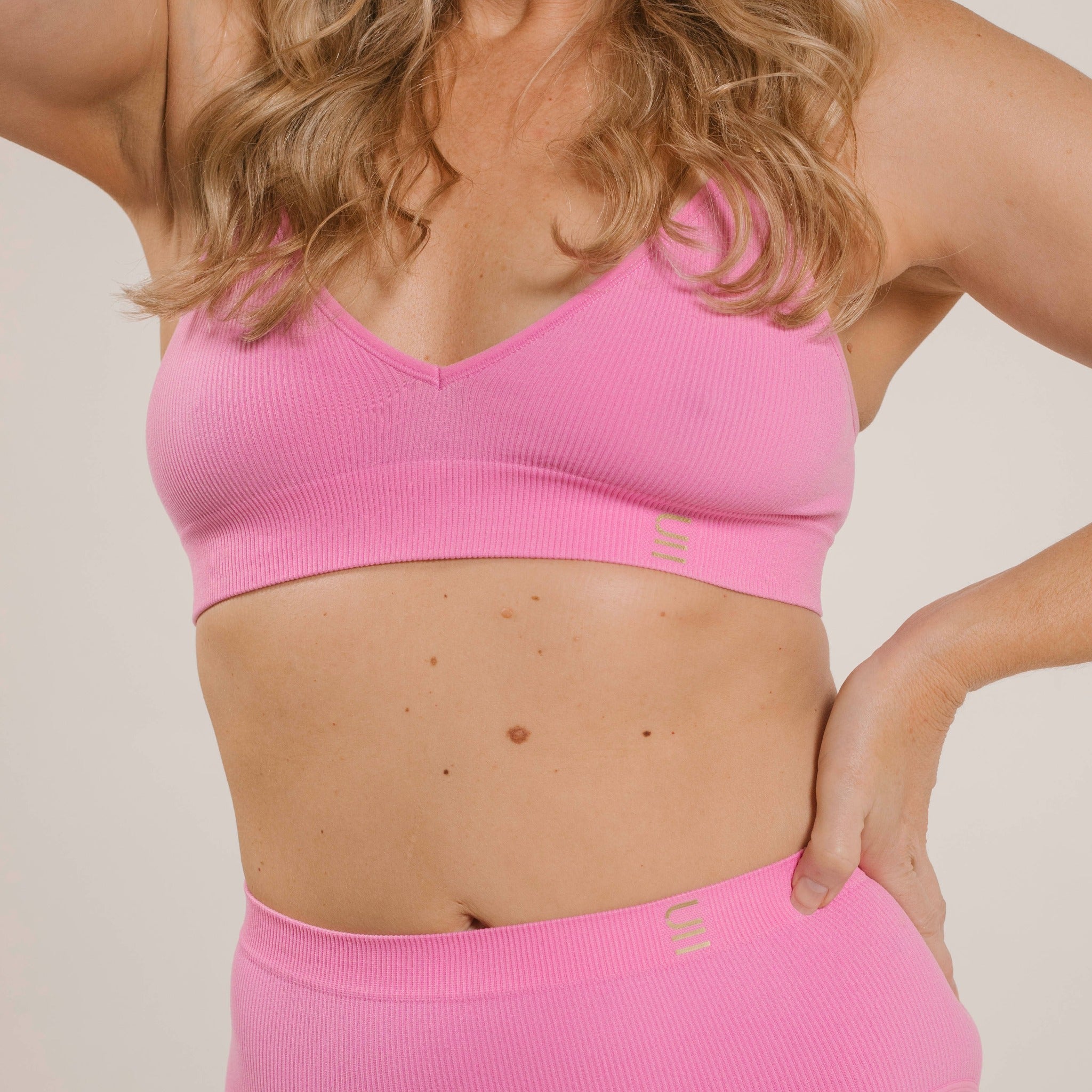 Sustainable, ethically produced pink wireless bra by Underwear for Humanity. A -D cup sizes. Recycled materials, flexible, supportive. Knitted bra and band, adjustable straps. Models wear the A-D bra.