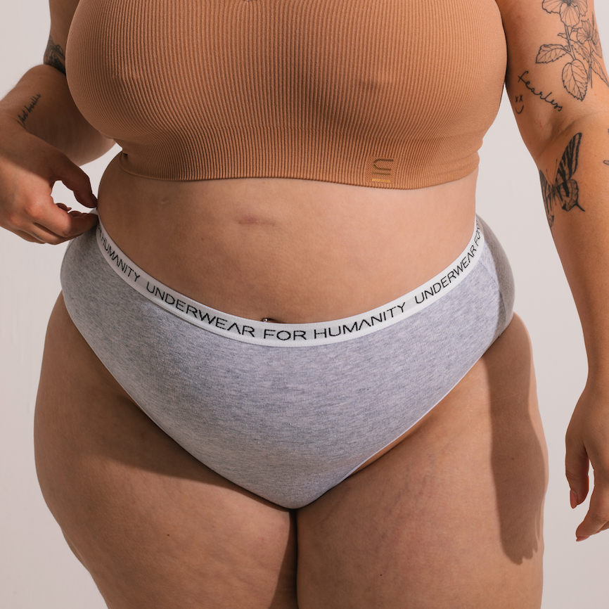 Underwear for Humanity, sustainable, organic and ethically made grey marle cotton underwear. Soft , breathable, full coverage, sits high on waist. Model wears High waisted Cotton underwear in black with a grey marle, recycled nylon elastic waist band.