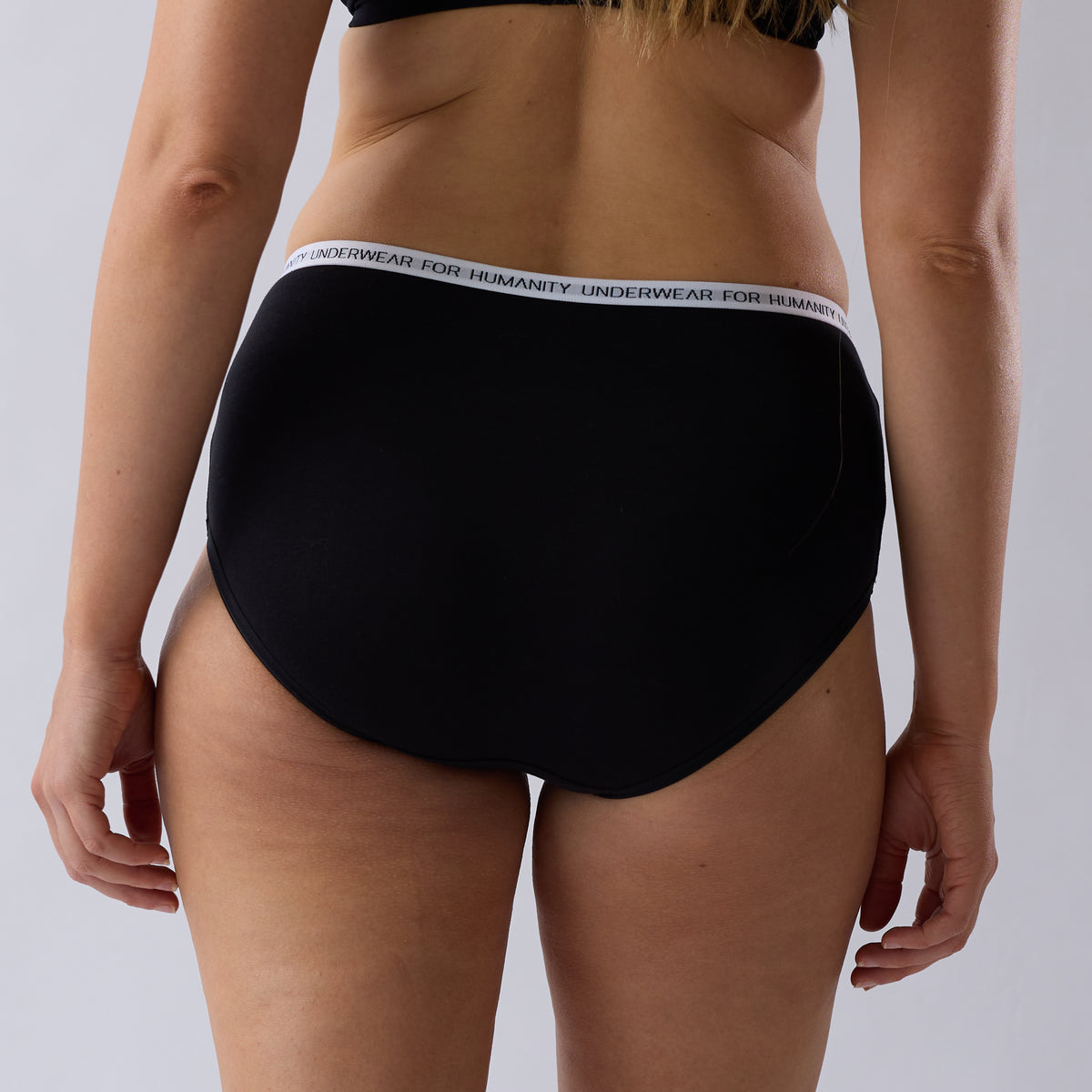Underwear for Humanity Organic Cotton Midi Brief in Black, a lower-rise women’s underwear style with a lower-cut leg, soft breathable fabric and comfortable everyday coverage