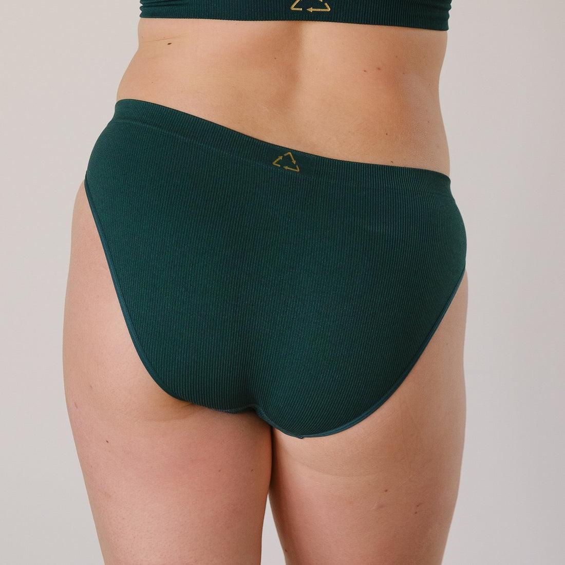 Sustainable, ethically made Atlantis high waist seam free brief by Underwear for Humanity: Flexible and comfortable, stretches across sizes. Models wear high waisted ethical underwear. Underwear is made from recycled nylon and sits high on the waist, full seat coverage and smooth on the body.