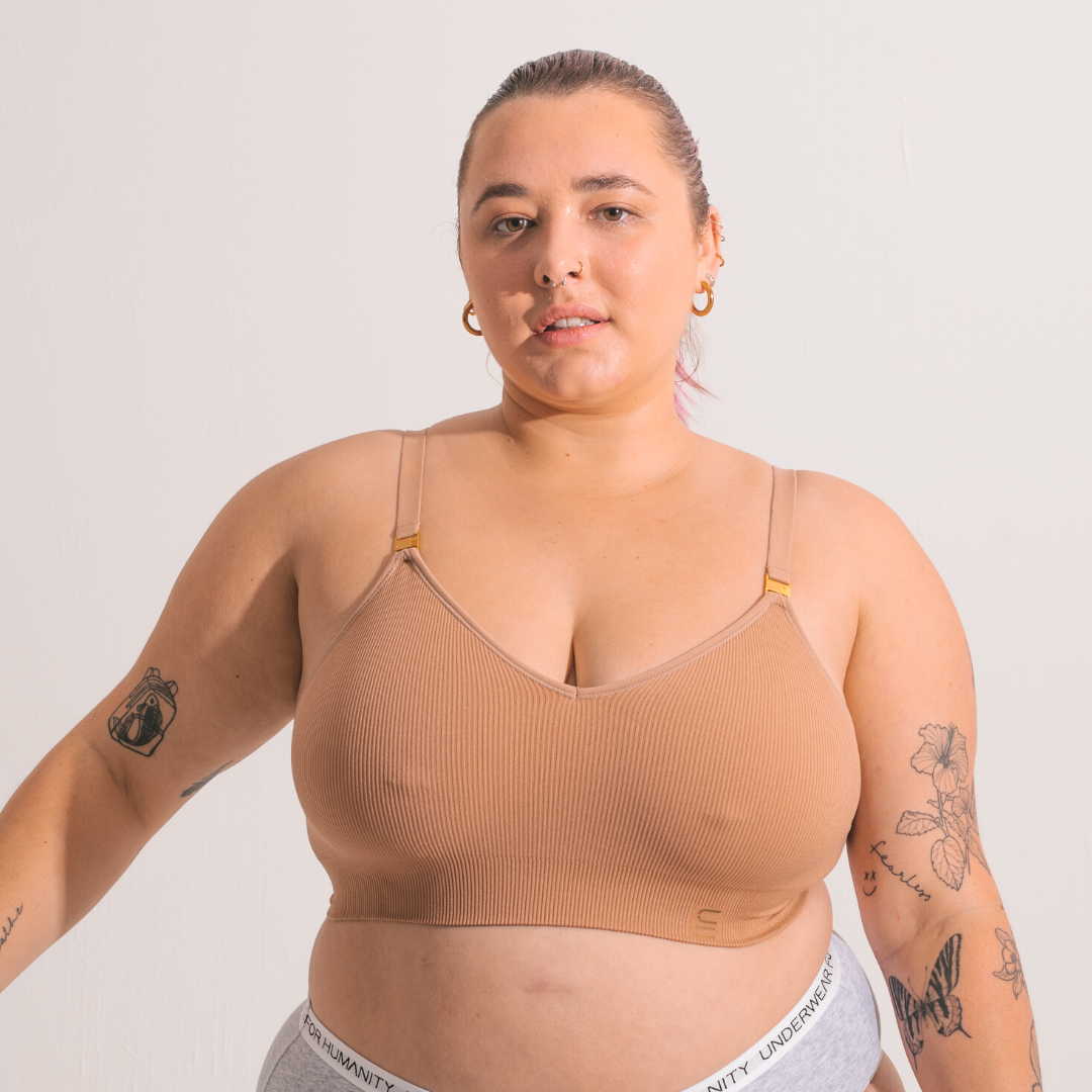 Sustainable, ethically produced nude 3 - light beige skin tone wireless bra by Underwear for Humanity. For DD-GG cup sizes. Recycled materials, flexible, supportive. Knitted bra and band, adjustable straps. Model wears the DD+ bra.