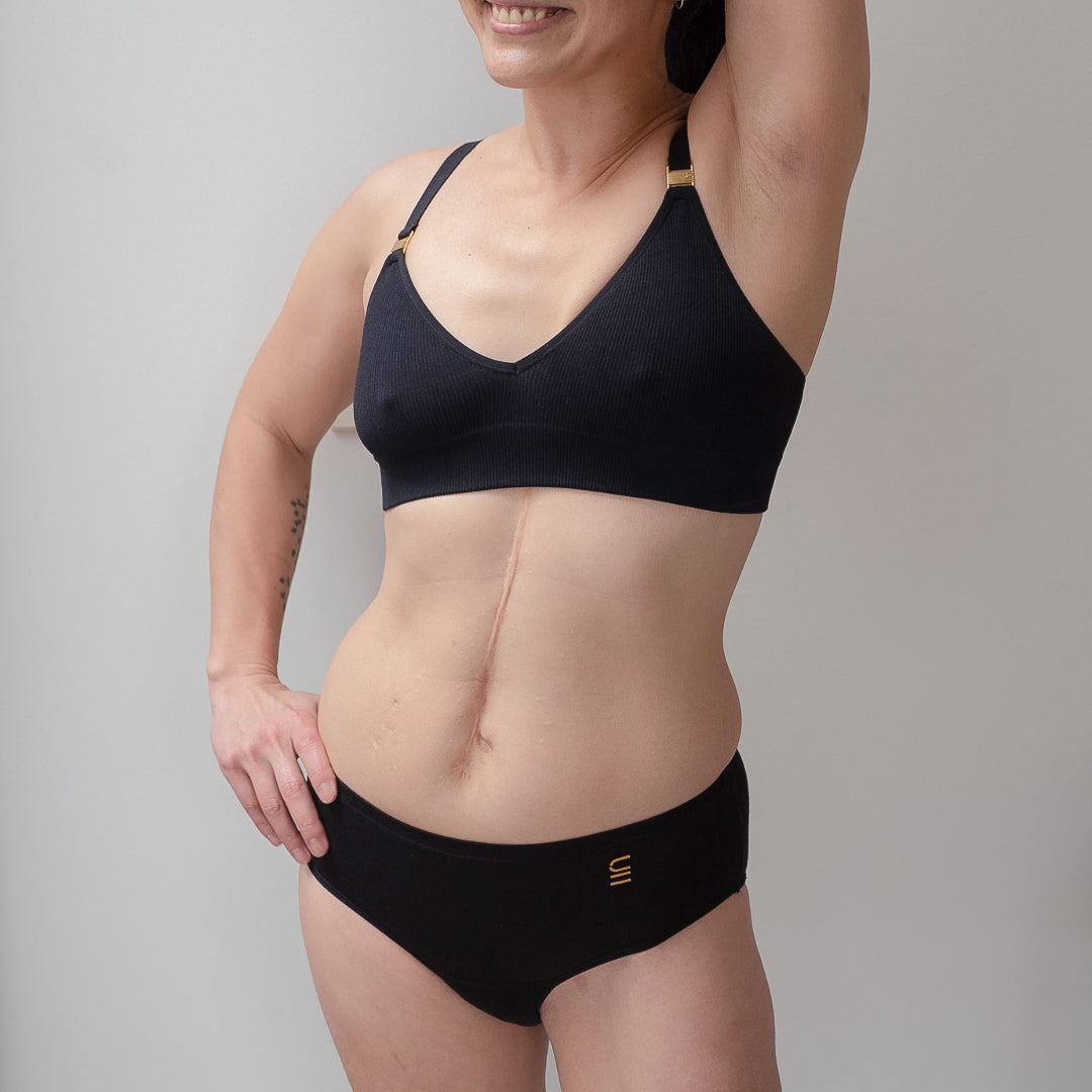 Sustainable, ethically made black wee or period undies. Absorbent without bulk. 1 day worth of wear or 3 tampons worth of protection. Suitable for day time use only. Toxin free, naturally antibacterial. Model wears daytime wee or period undies.