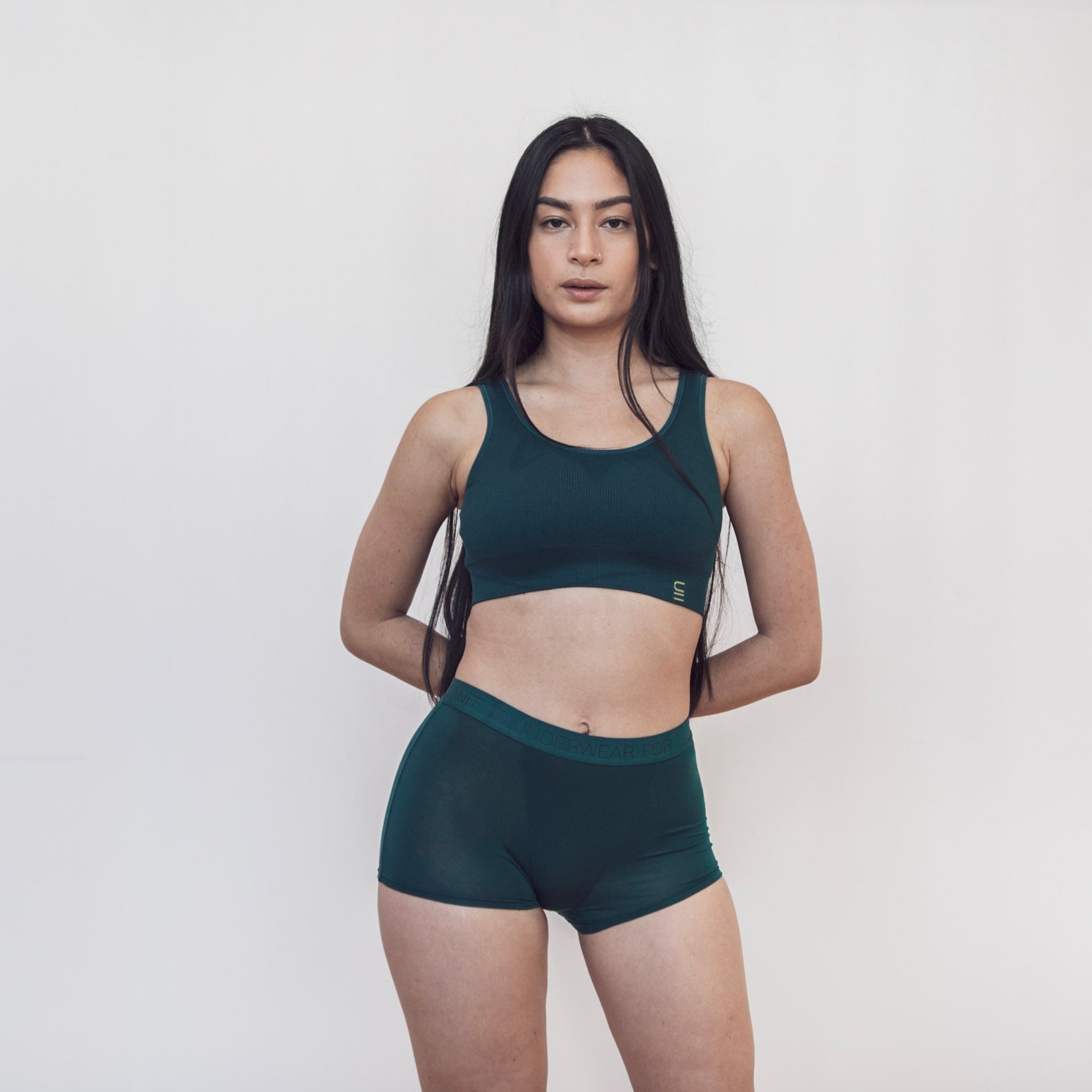 Sustainable, ethically produced atlantis shorts by Underwear for Humanity. Mid-rise, full coverage seat, thin, no-dig, elastic waist, short length sits higher on the leg. Made from sustainable tencel and recycled elastic. Models wear the shorts.