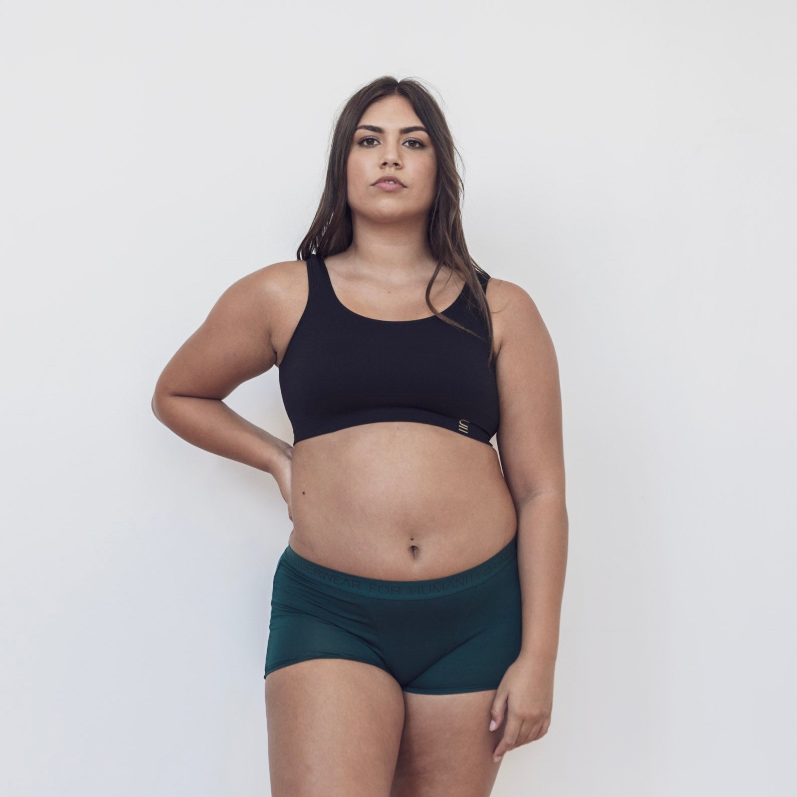 Sustainable, ethically produced atlantis shorts by Underwear for Humanity. Mid-rise, full coverage seat, thin, no-dig, elastic waist, short length sits higher on the leg. Made from sustainable tencel and recycled elastic. Models wear the shorts.