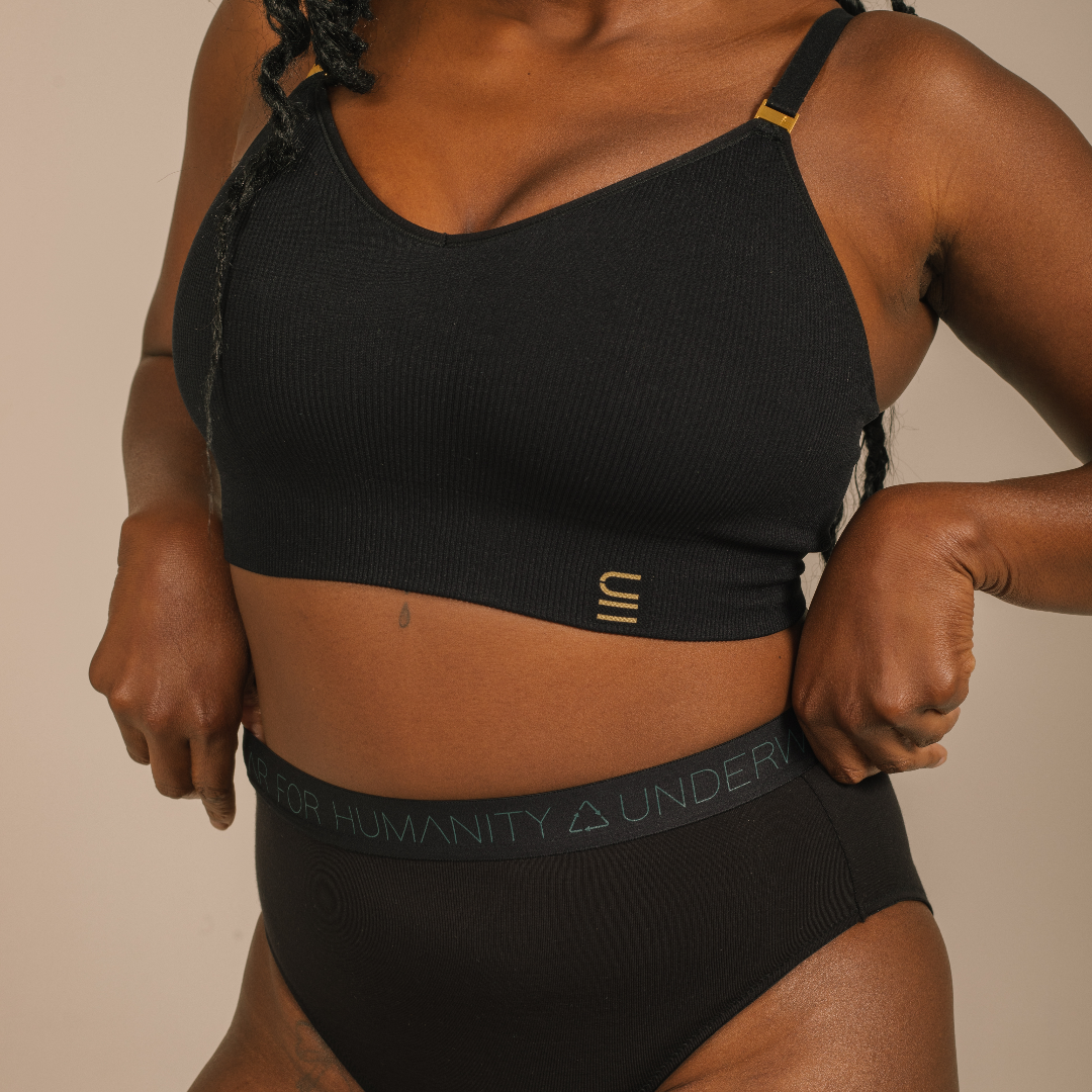 Sustainable black high waist brief by Underwear for Humanity: ethical, sustainable. sizes 6-30 light, breathable. Models wear high-waisted underwear. underwear sits high on the waist, full seat coverage. smooth under clothing. made from Tencel and recycled materials, attached no-dig recycled elastic waist band.