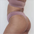 Sustainable bruised mauve high waist g-string by Underwear for Humanity: ethical, sustainable. sizes 6-26. Models wear high-waisted G -string underwear. underwear sits high on the waist, sits smooth on the body, made from Tencel and recycled materials.