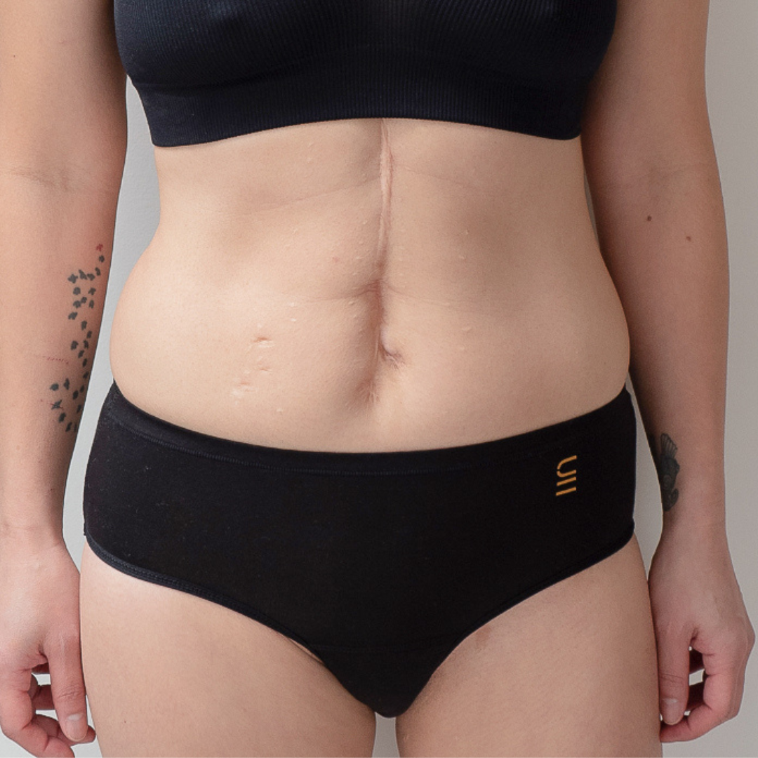 Sustainable, ethically made black wee or period undies. Absorbent without bulk. 1 day worth of wear or 3 tampons worth of protection. Suitable for day time use only. Toxin free, naturally antibacterial. Model wears daytime wee or period undies.