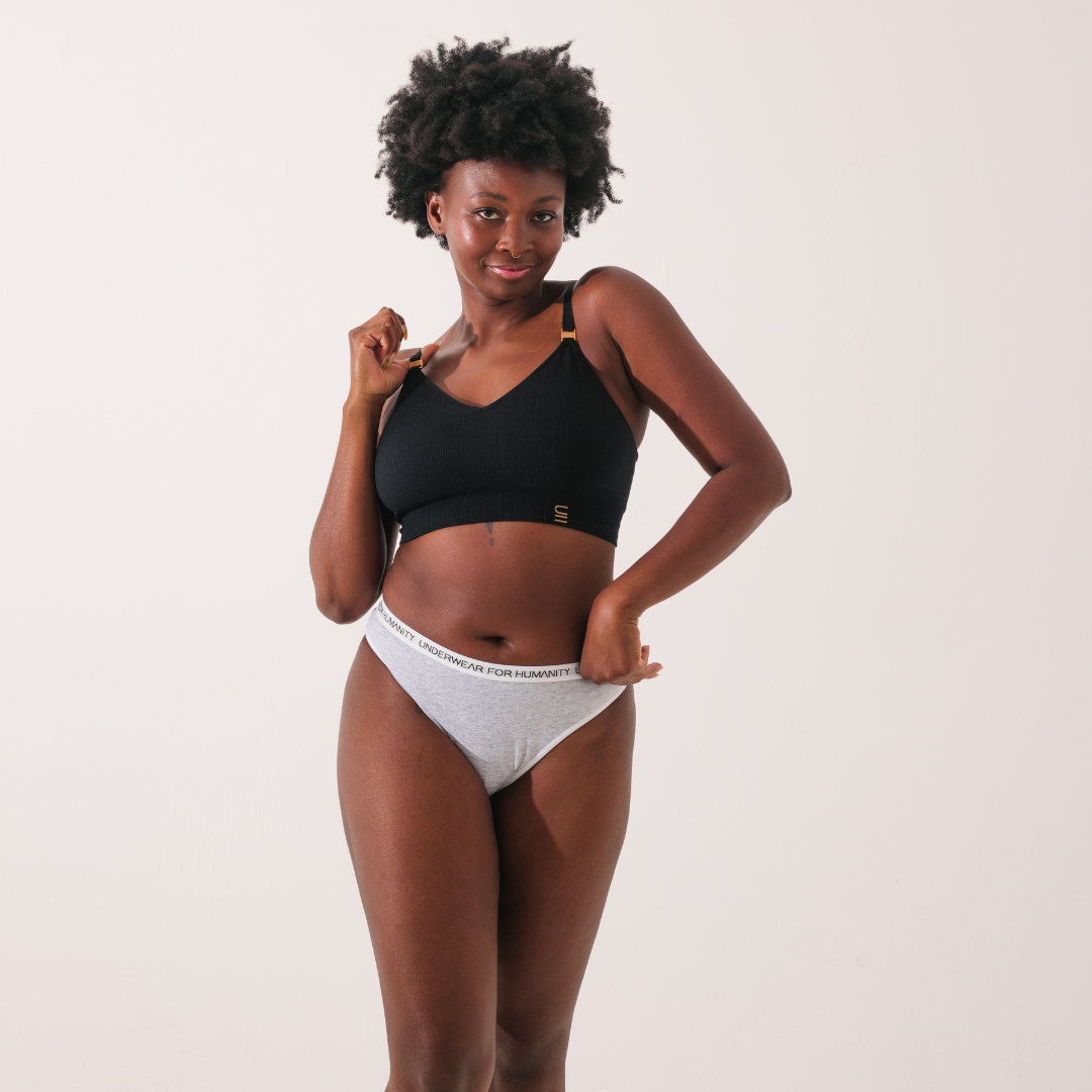 Underwear for Humanity, sustainable, organic and ethically made white cotton underwear. Soft , breathable, Cheeky coverage, sits high on hips. Model wears Cheeky Cotton underwear in white with a white, recycled nylon elastic waist band.