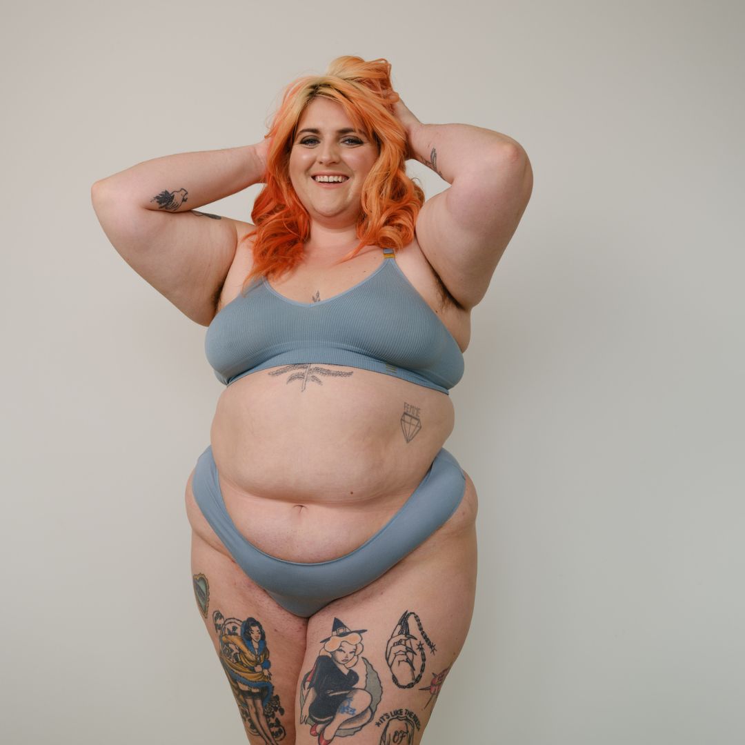 Sustainable mineral blue high waist g-string by Underwear for Humanity: ethical, sustainable. sizes 6-26. Models wear high-waisted G -string underwear. underwear sits high on the waist, sits smooth on the body, made from Tencel and recycled materials.