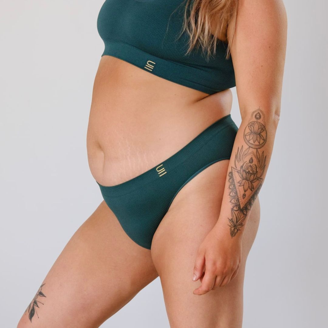 Ethically made recycled seam free atlantis bikini brief by Underwear for Humanity: Flexible and comfortable, stretches across sizes. Models wear bikini brief underwear. Underwear is made from recycled nylon and sits low on the waist, full seat coverage and smooth on the body.