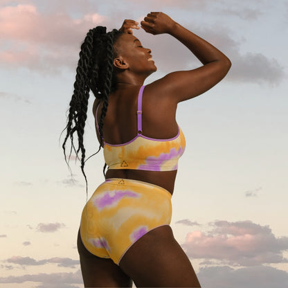 Nelly wears the sunrise tie dye high waist brief. made from soft recycled nylon, sustainable and ethically made