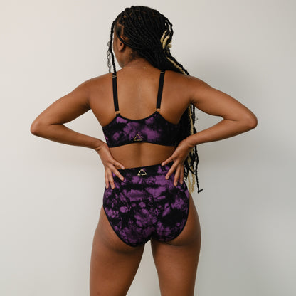 Sustainable Tie dye black and orchid tie dye seam free high waist brief by Underwear for Humanity: ethical, sustainable. sizes 6-26. light, breathable, stretches across sizes. Models wear high-waisted underwear. underwear sits high on the waist, full seat coverage, Seam free underwear. made from recycled nylon