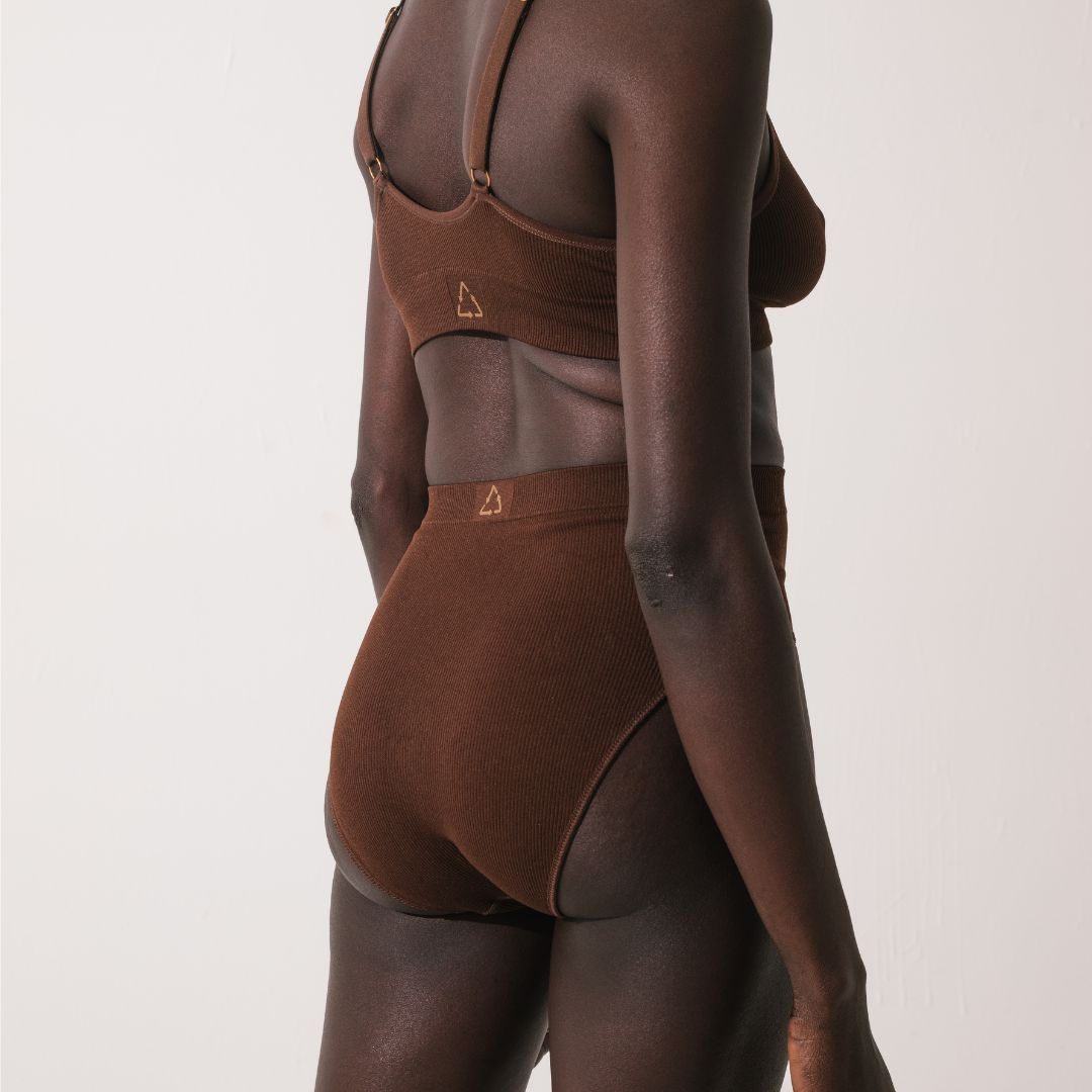 Sustainable nude 6- dark skin tone, seam free high waist brief by Underwear for Humanity: ethical, sustainable. sizes 6-26. light, breathable, stretches across sizes. Models wear high-waisted underwear. underwear sits high on the waist, full seat coverage, Seam free underwear. made from recycled nylon