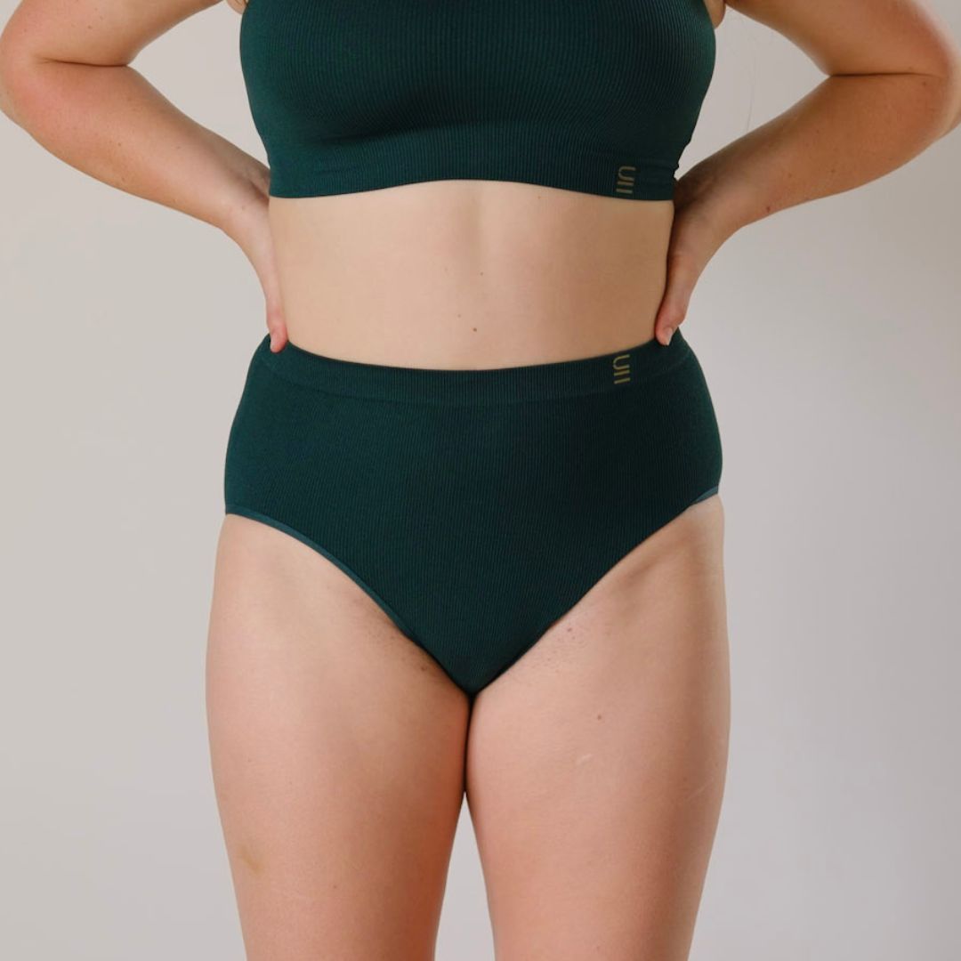 Sustainable, ethically made Atlantis high waist seam free brief by Underwear for Humanity: Flexible and comfortable, stretches across sizes. Models wear high waisted ethical underwear. Underwear is made from recycled nylon and sits high on the waist, full seat coverage and smooth on the body.