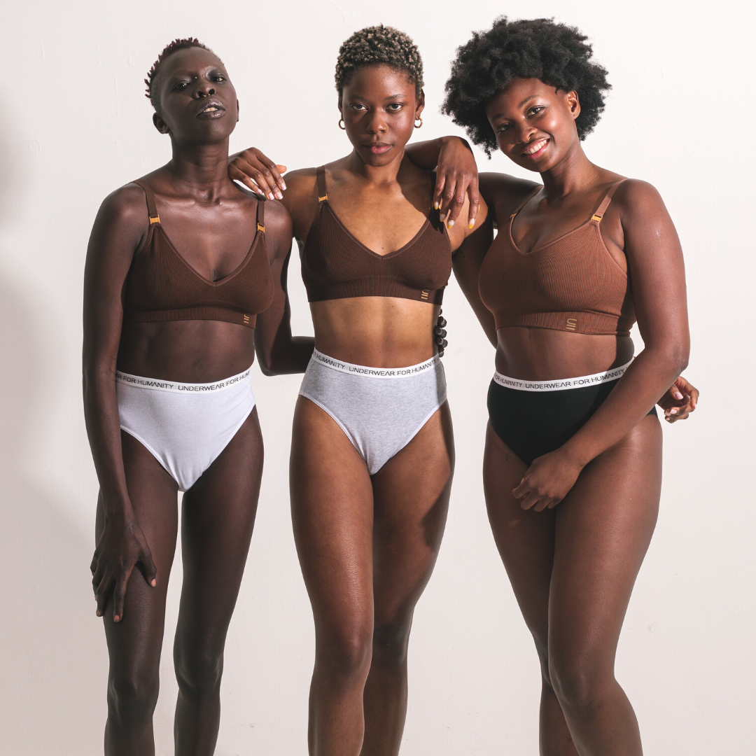 Models wear Underwear for Humanity Organic cotton underwear in black, grey and white with white recycled elastic waist band. 