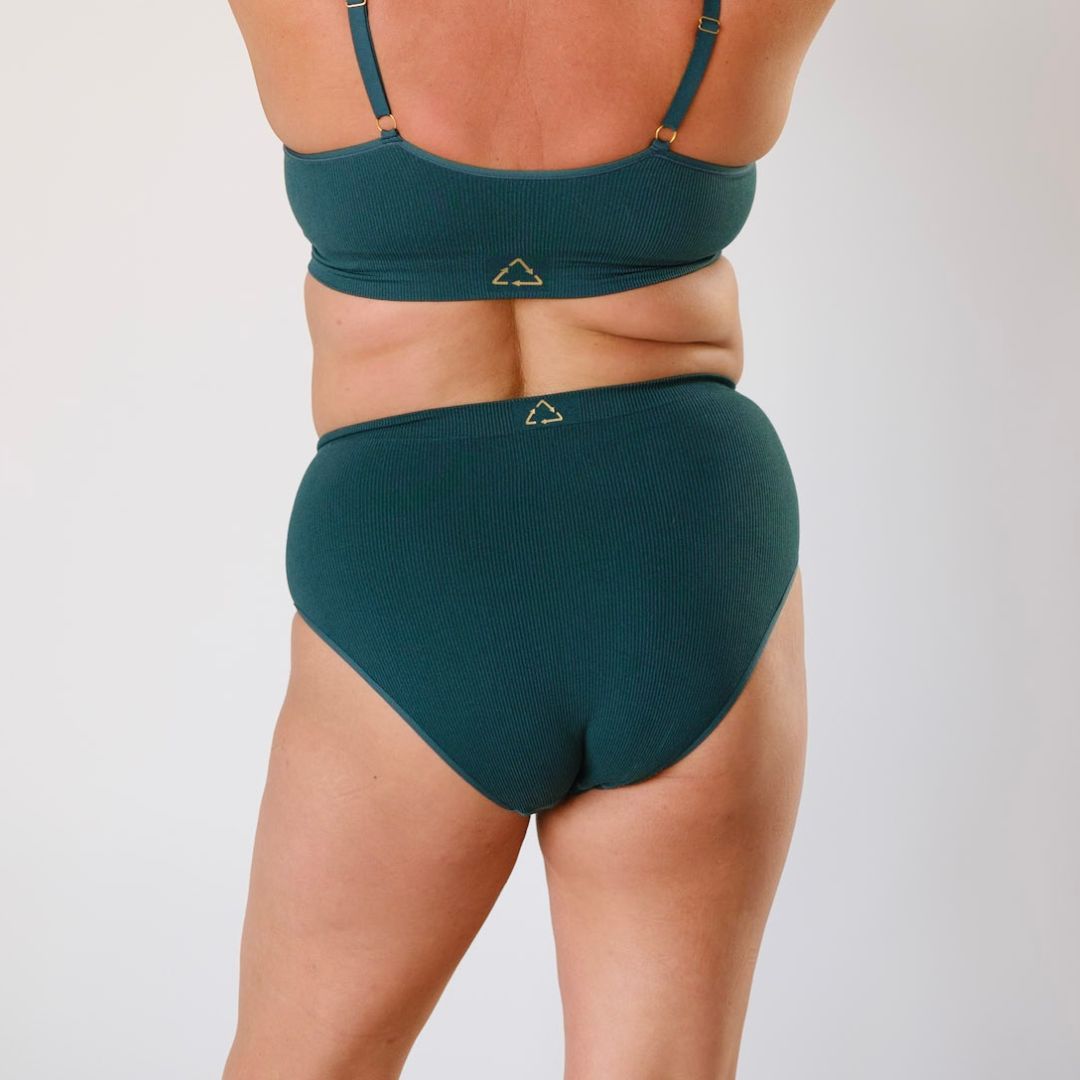 Sustainable, ethically made Atlantis high waist seam free brief by Underwear for Humanity: Flexible and comfortable, stretches across sizes. Models wear high waisted ethical underwear. Underwear is made from recycled nylon and sits high on the waist, full seat coverage and smooth on the body.