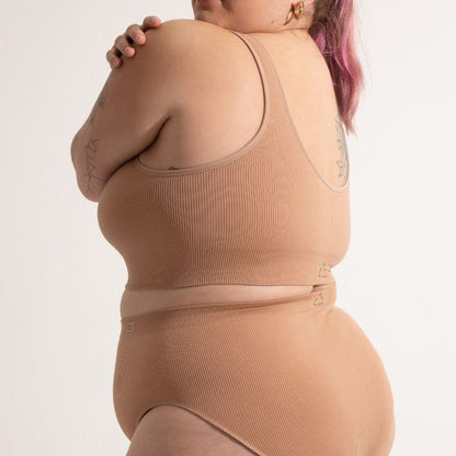 Sustainable, ethically produced nude 3- light beige skin tone bra crop by Underwear for Humanity: stronger support for larger bust, D - GG cup sizes. Recycled materials, knitted bra and band, seamfree, made from recycled nylon. Models wear the D+ Crop