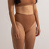 Sustainable nude 4 tan olive skin tone seam free high waist brief by Underwear for Humanity: ethical, sustainable. sizes 6-26. light, breathable, stretches across sizes. Models wear high-waisted underwear. underwear sits high on the waist, full seat coverage, Seam free underwear. made from recycled nylon