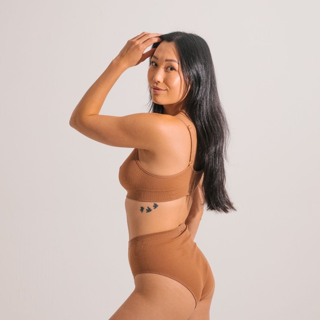 Sustainable, ethically produced nude 4 - tan olive skin tone wireless bra by Underwear for Humanity. A -D cup sizes. Recycled materials, flexible, supportive. Knitted bra and band, adjustable straps. Models wear the A-D bra.